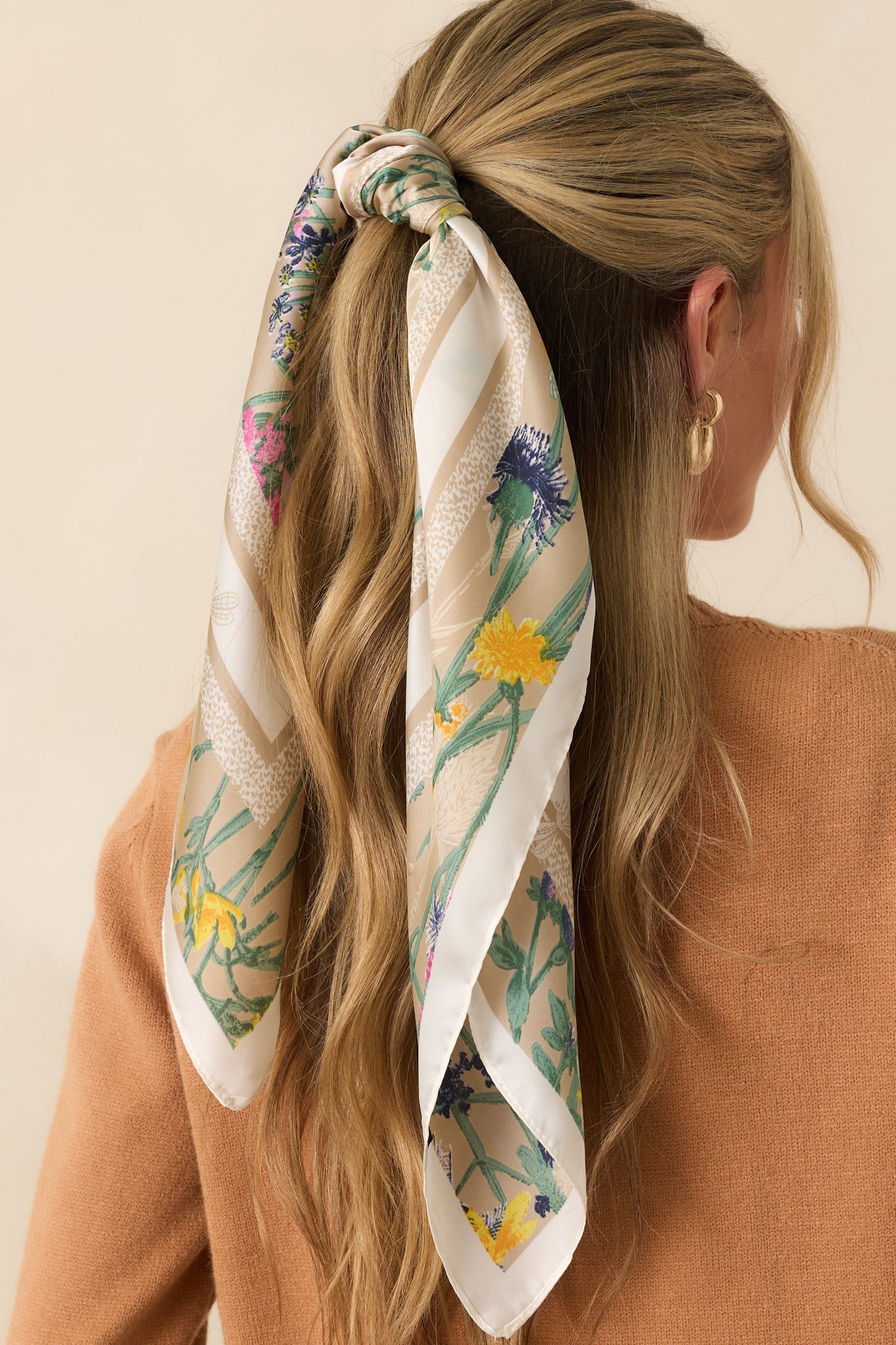 A back view of the beige satin square scarf showcasing a floral center and contrasting animal print border.