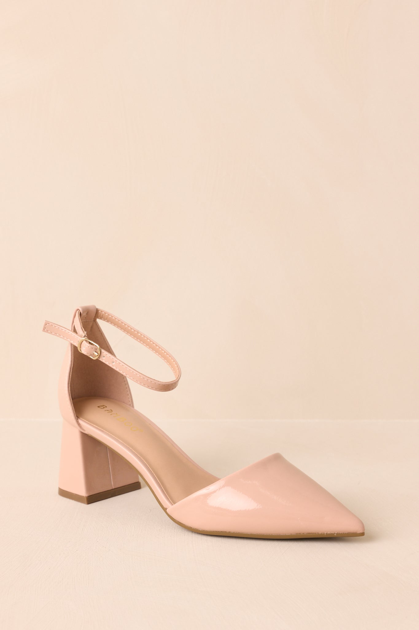 Three-quarter angle of the heel displaying the glossy texture and minimal design.