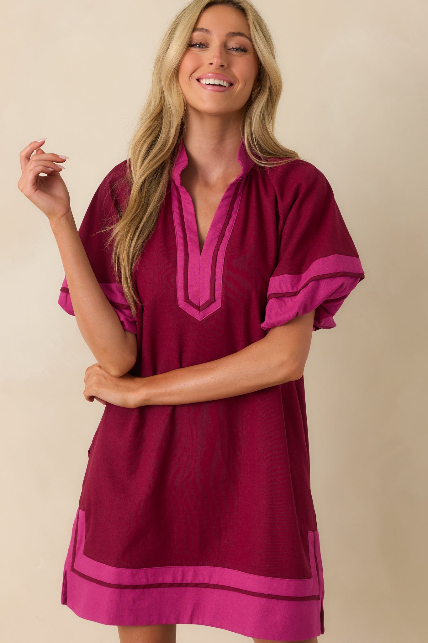 Cropped front image focusing on the notch v-neckline and pink contrast trim detailing.