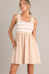 Front view of this dress that features a charming square neckline, complemented by adjustable scalloped straps and a flattering smocked back insert.