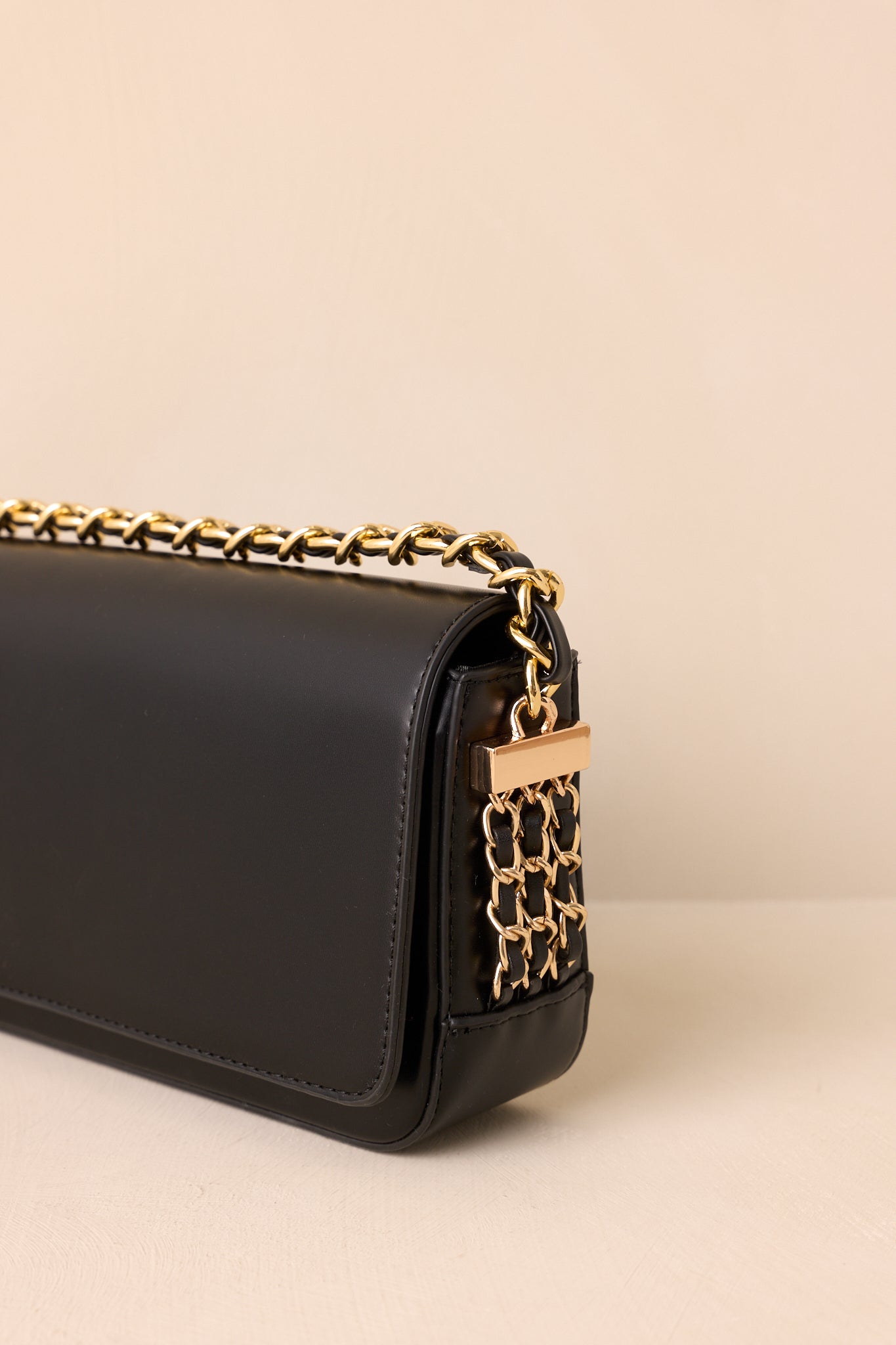 Detailed view of faux leather texture, chain strap, and side chain accents.