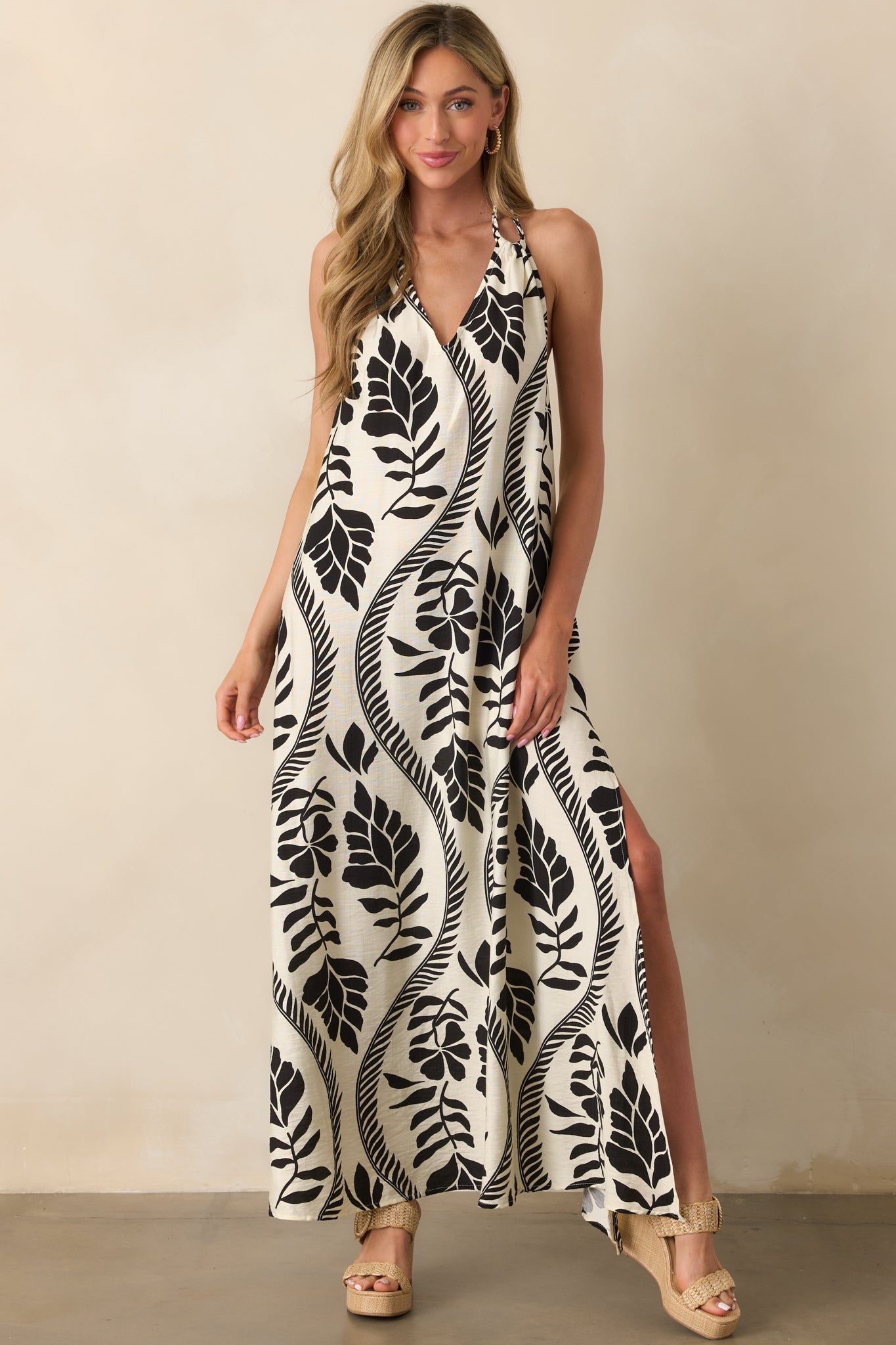 Full body image highlighting the relaxed fit of the dress and the braided strap details framing the neckline.