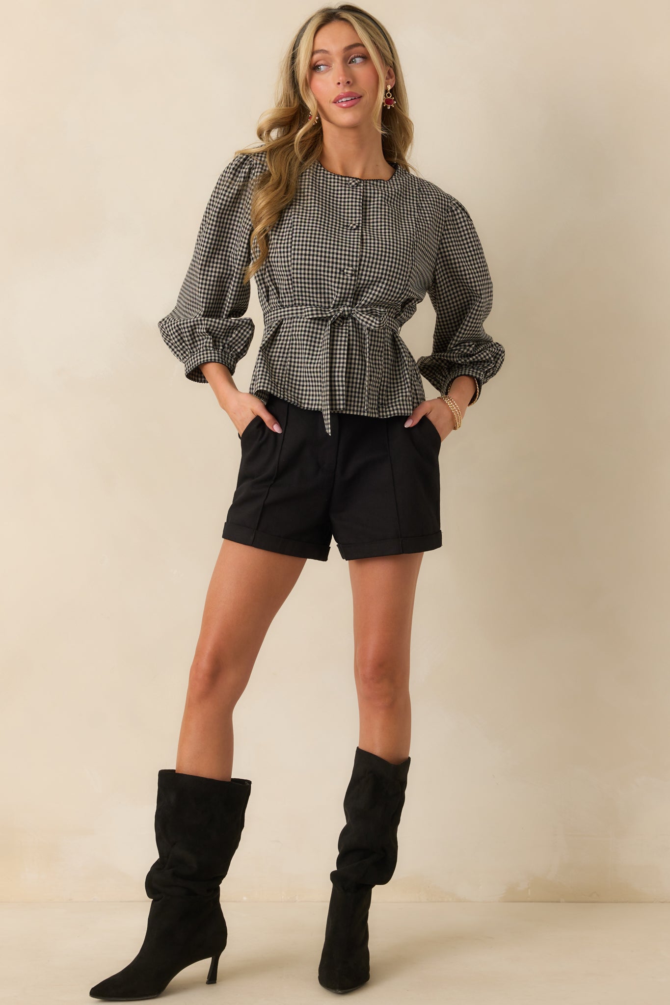 Black gingham blouse with a button-up front and 3/4 length puff sleeves.