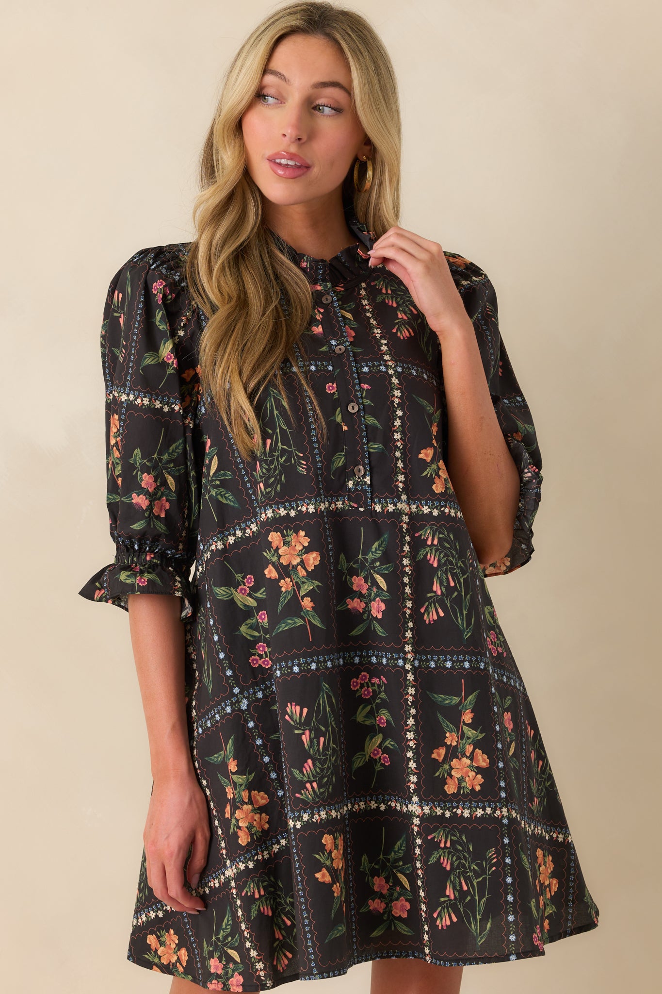 A cropped image focusing on the lower portion of the dress and the placement of the floral block print near the hem.