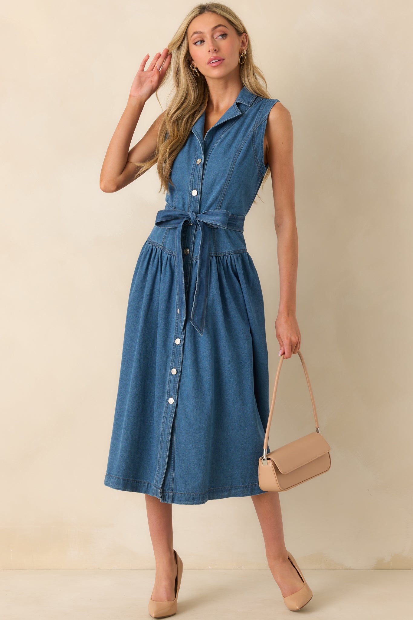 Another front view of the collared blue denim dress featuring a button front closure and midi length cut.