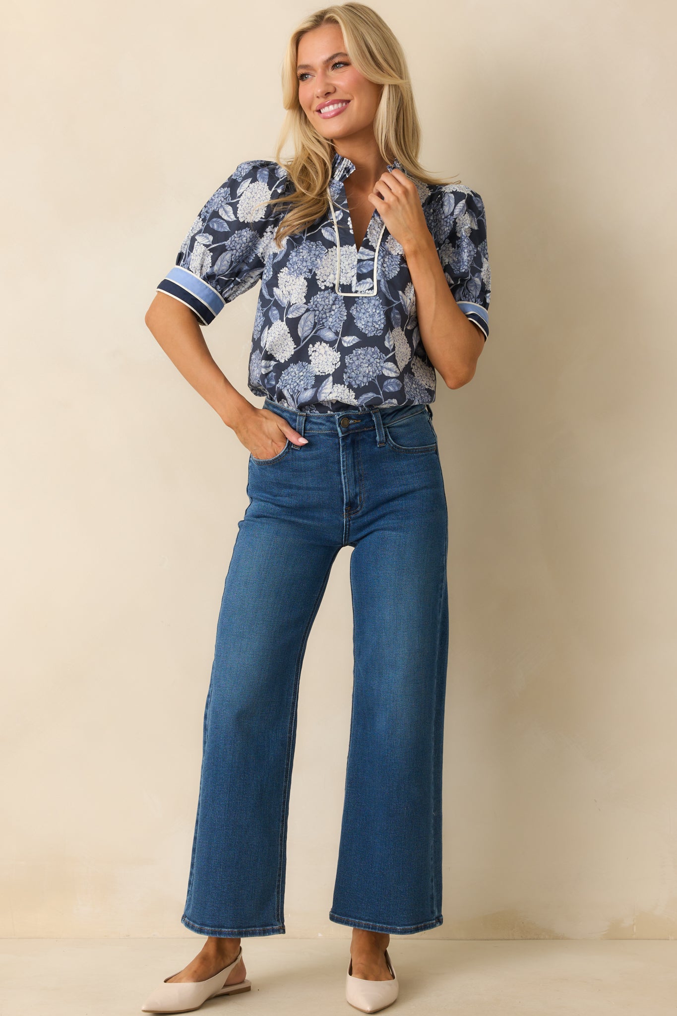 Casual blouse with notch-v-neck and pleated ruffle trim, styled in blue floral print.