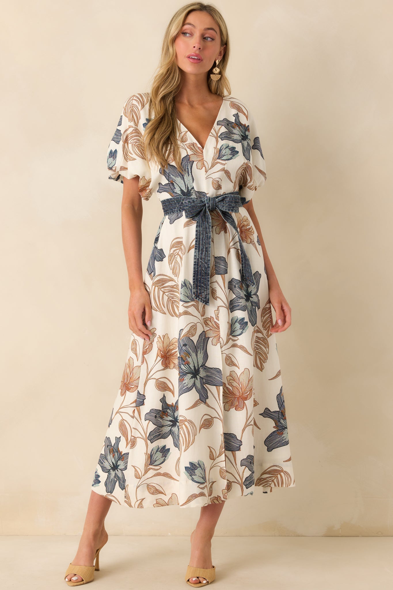 Full body front view of the maxi dress featuring a v-neckline, short puff sleeves with elastic cuffs, and a paneled silhouette.