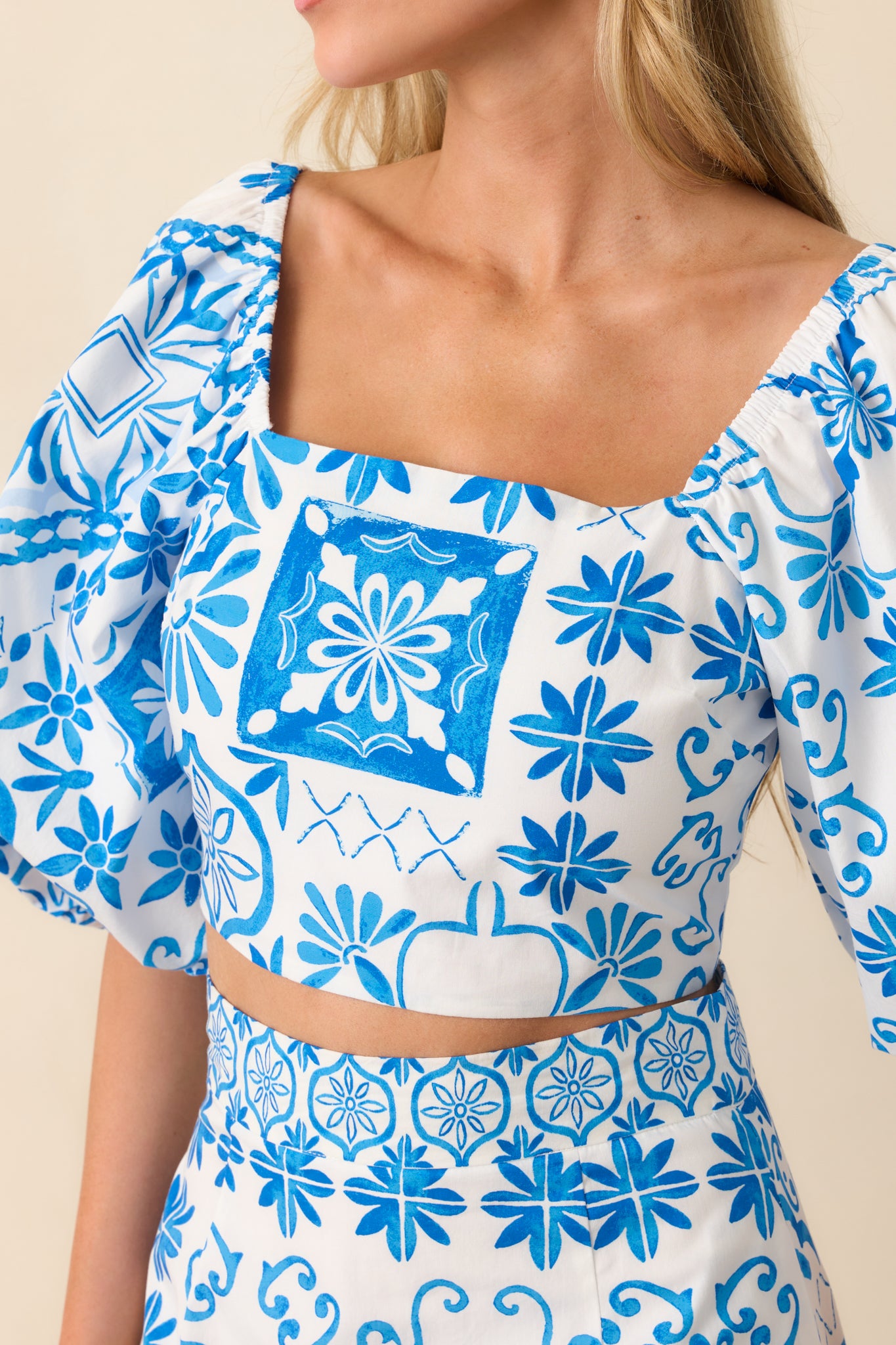 Detailed close-up of the fabric and print, showing the intricacy of the Aegean blue tile pattern.