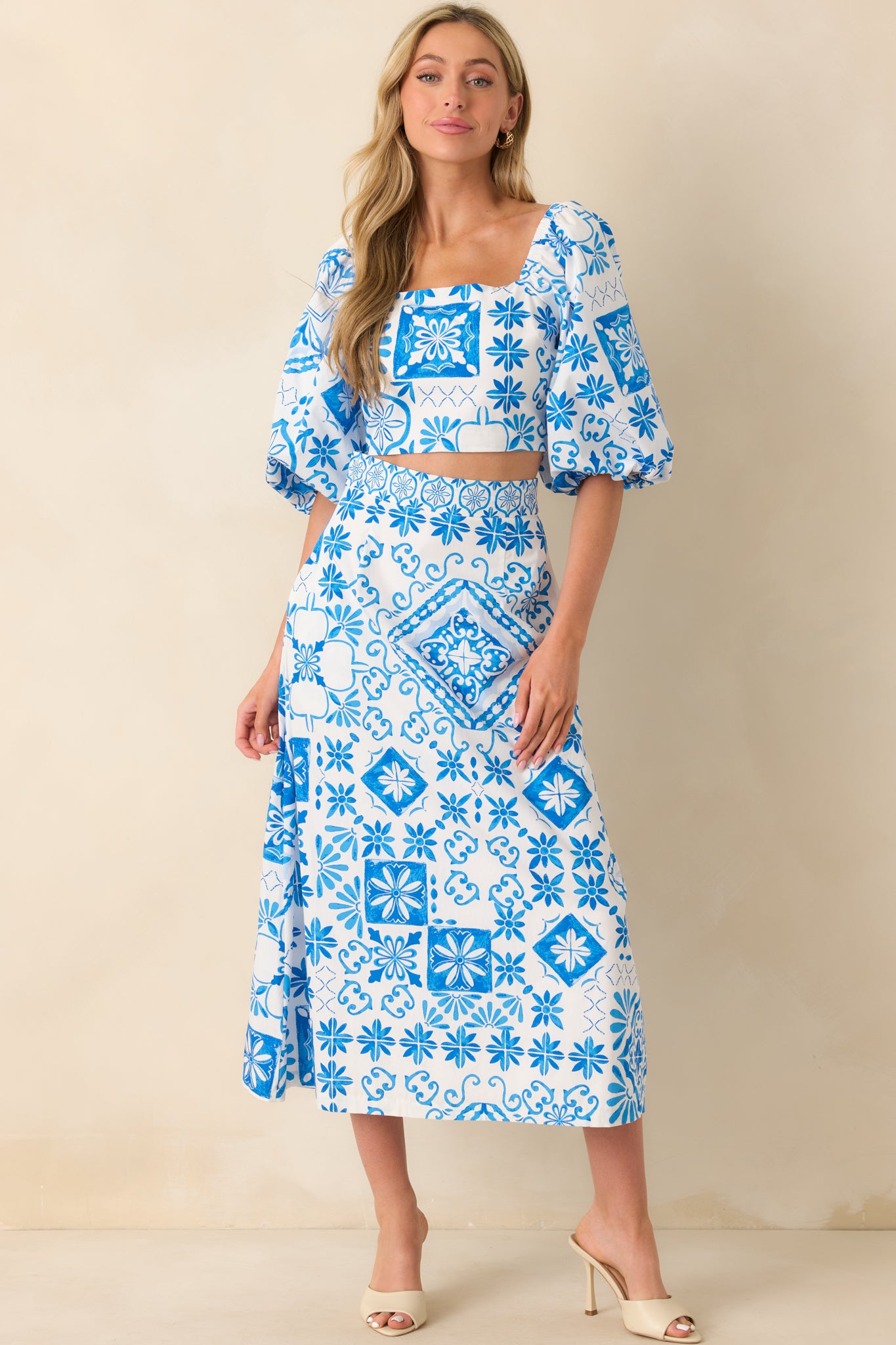 Full body shot showing the structured square neckline and volume in the puff sleeves with elastic cuffs.