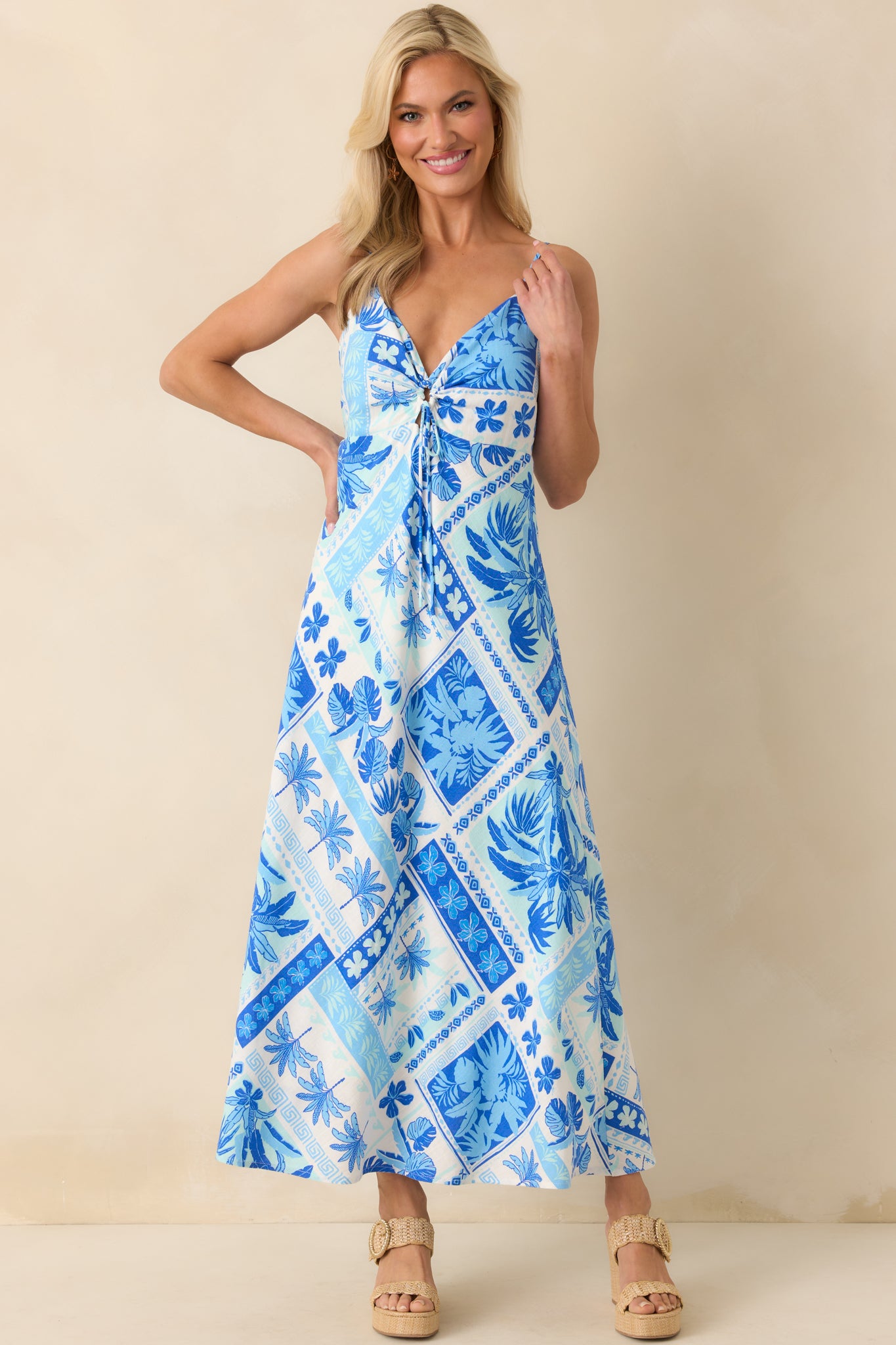 Full body image emphasizing the layered drape and structure of the maxi dress with its tropical blue patchwork design.