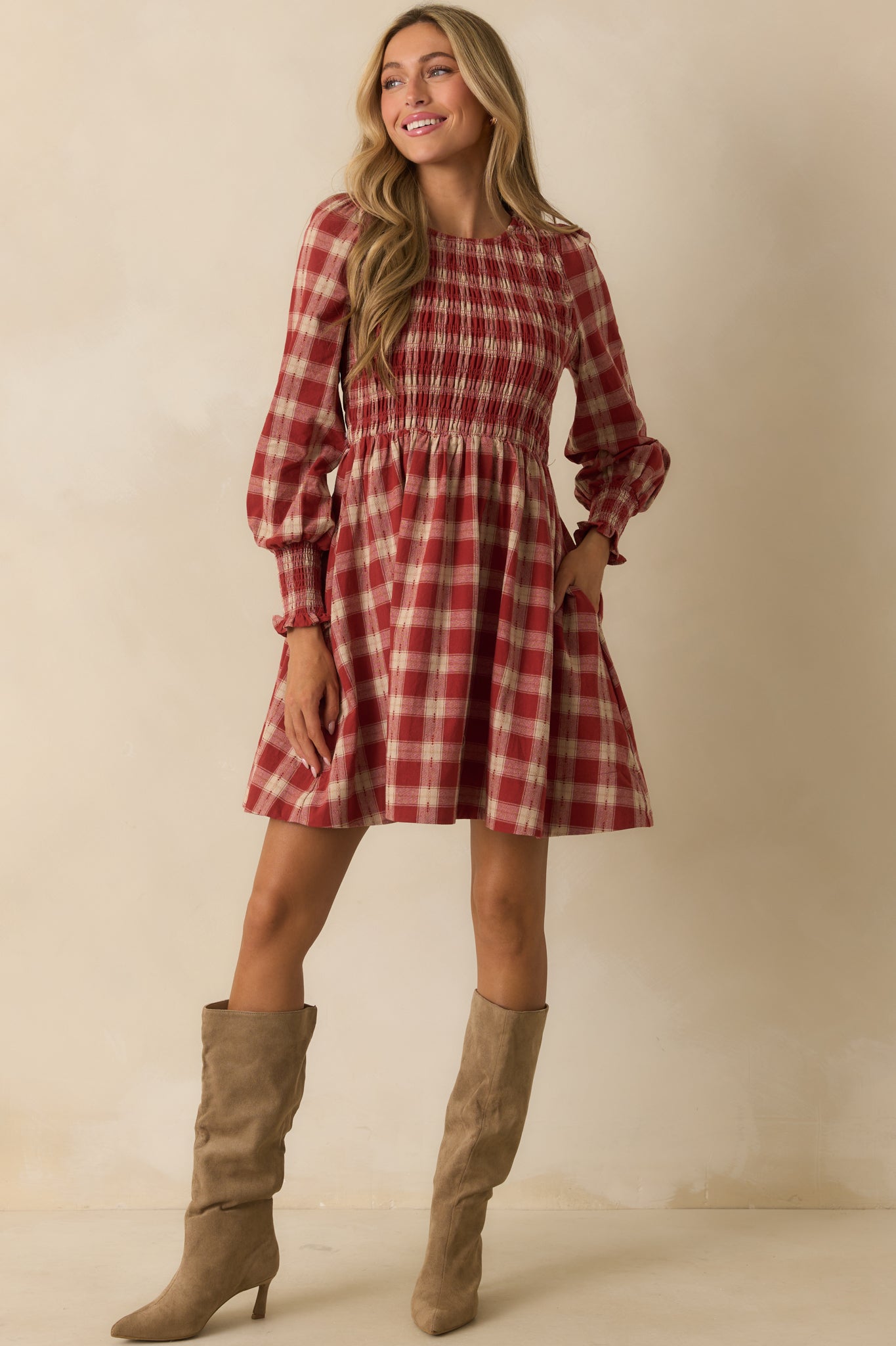Brick red gingham mini dress styled with a crew neckline and softly gathered puff sleeves.