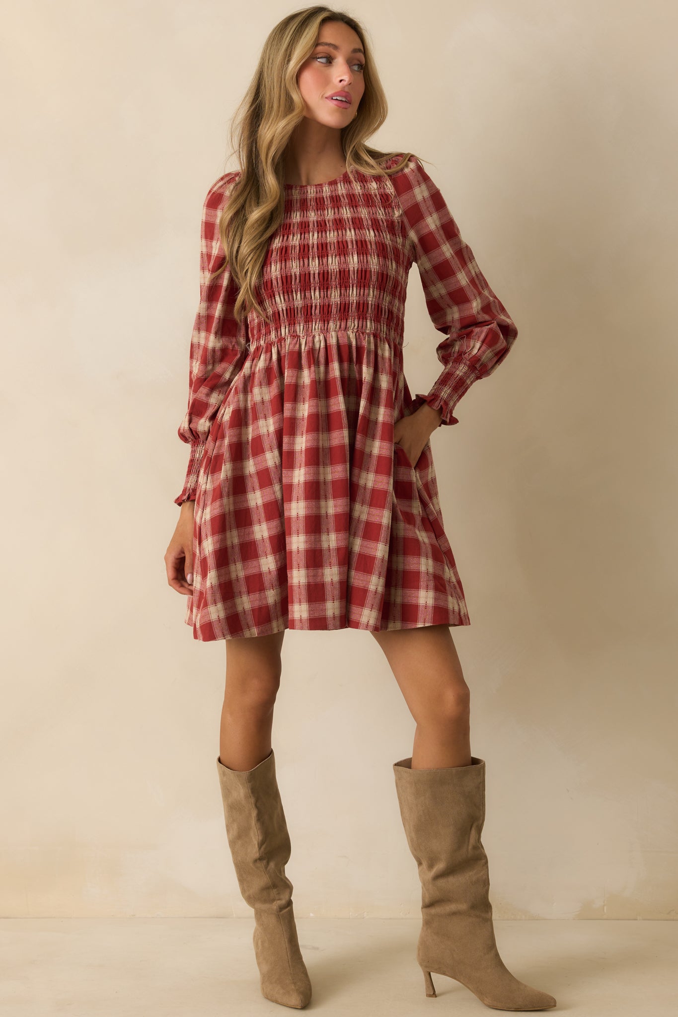 Mini dress in brick red gingham with a crew neckline and smocked sleeve cuffs.