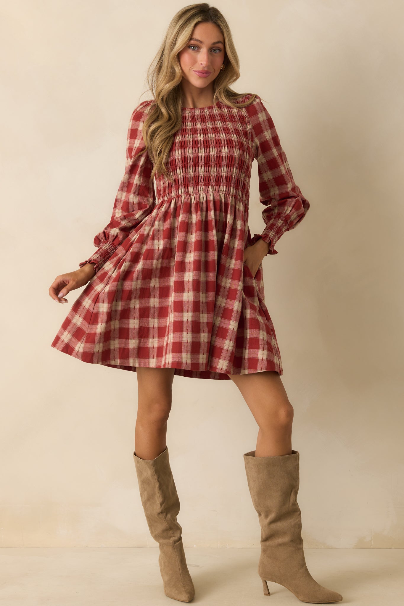 Brick red gingham mini dress with a fully smocked bodice and long puff sleeves.