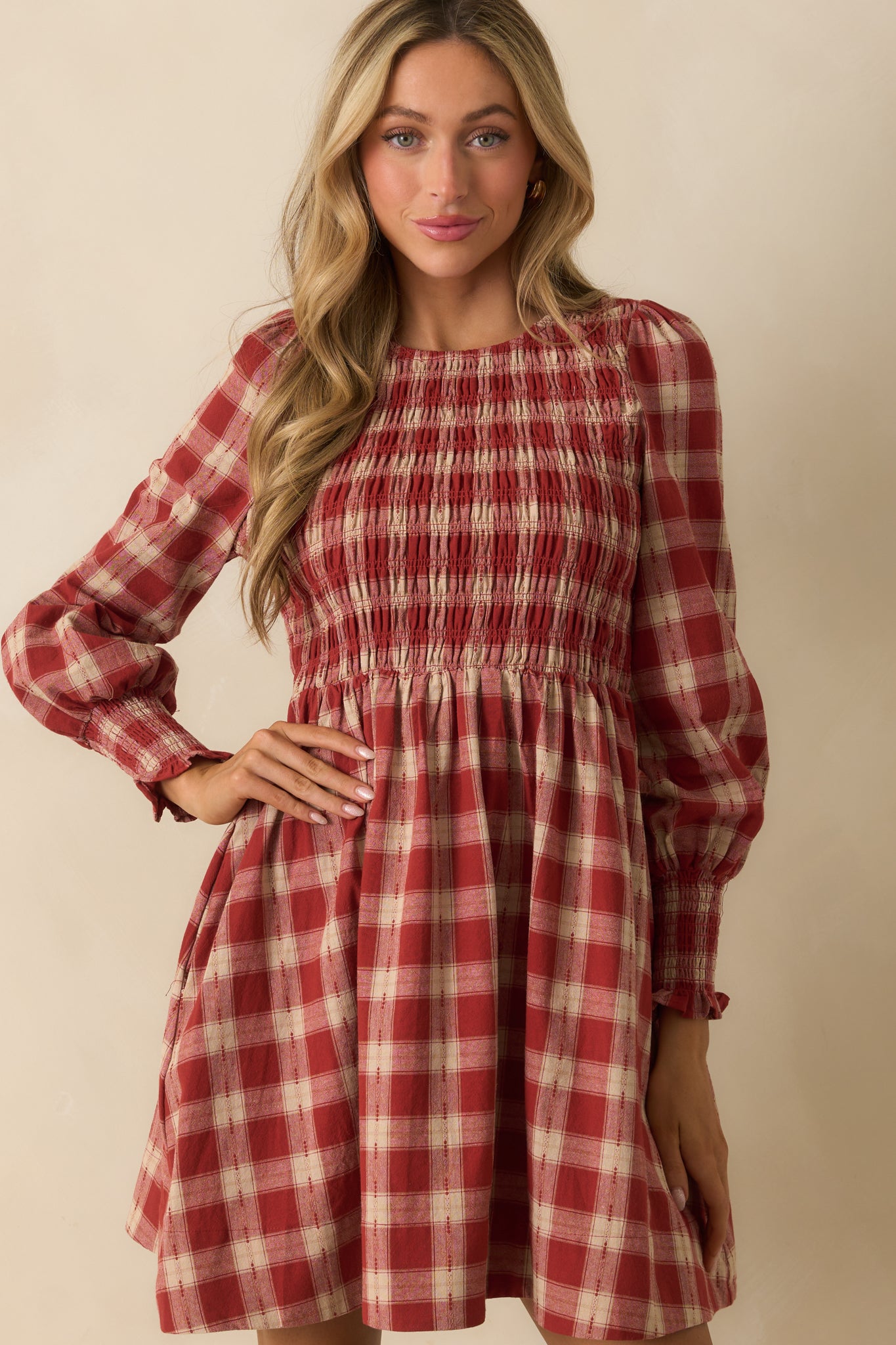 Smocked sleeve cuff in brick red gingham with puff sleeve volume above.