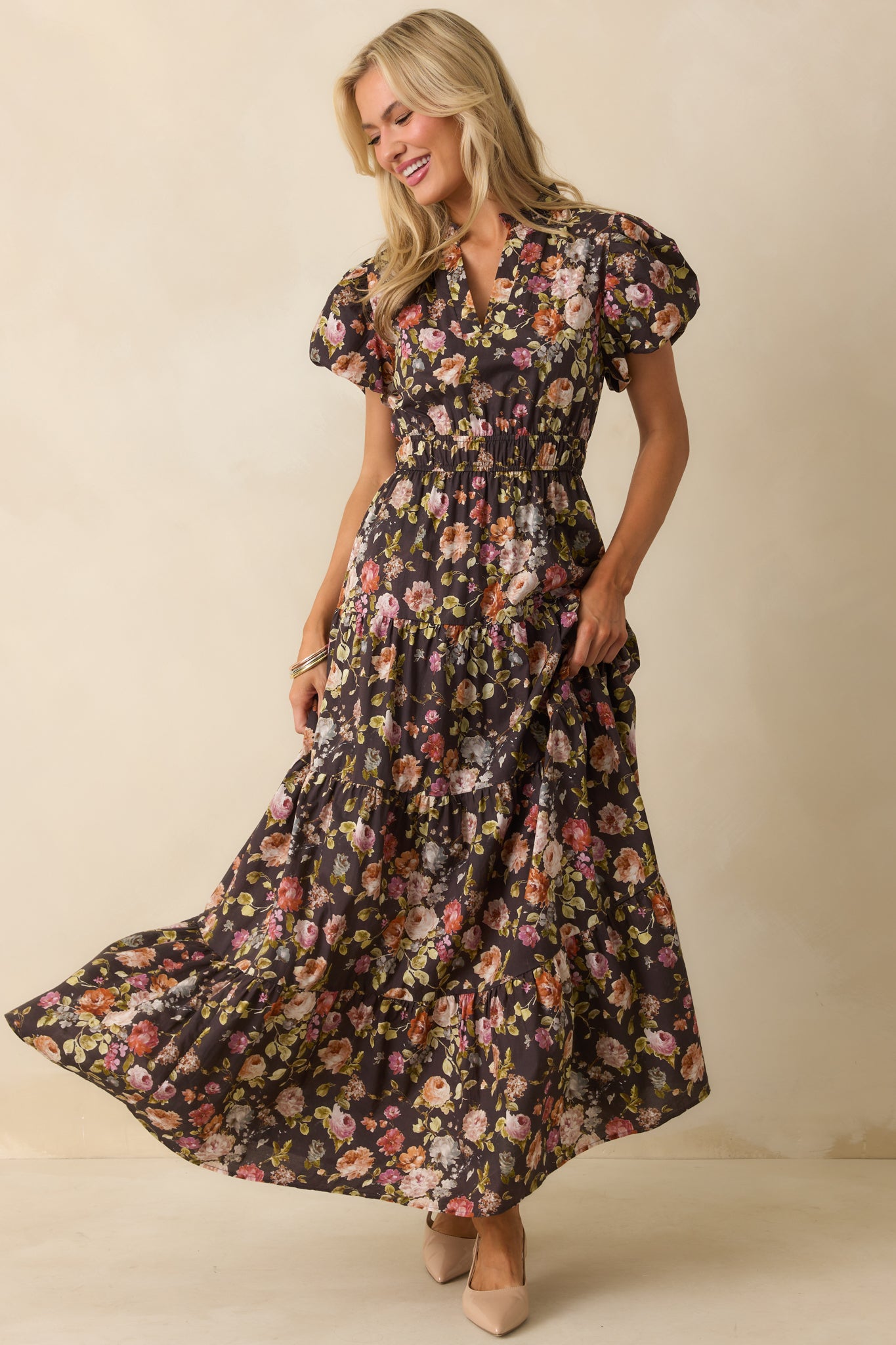 Brown maxi dress with a multicolor floral print and a tiered skirt.