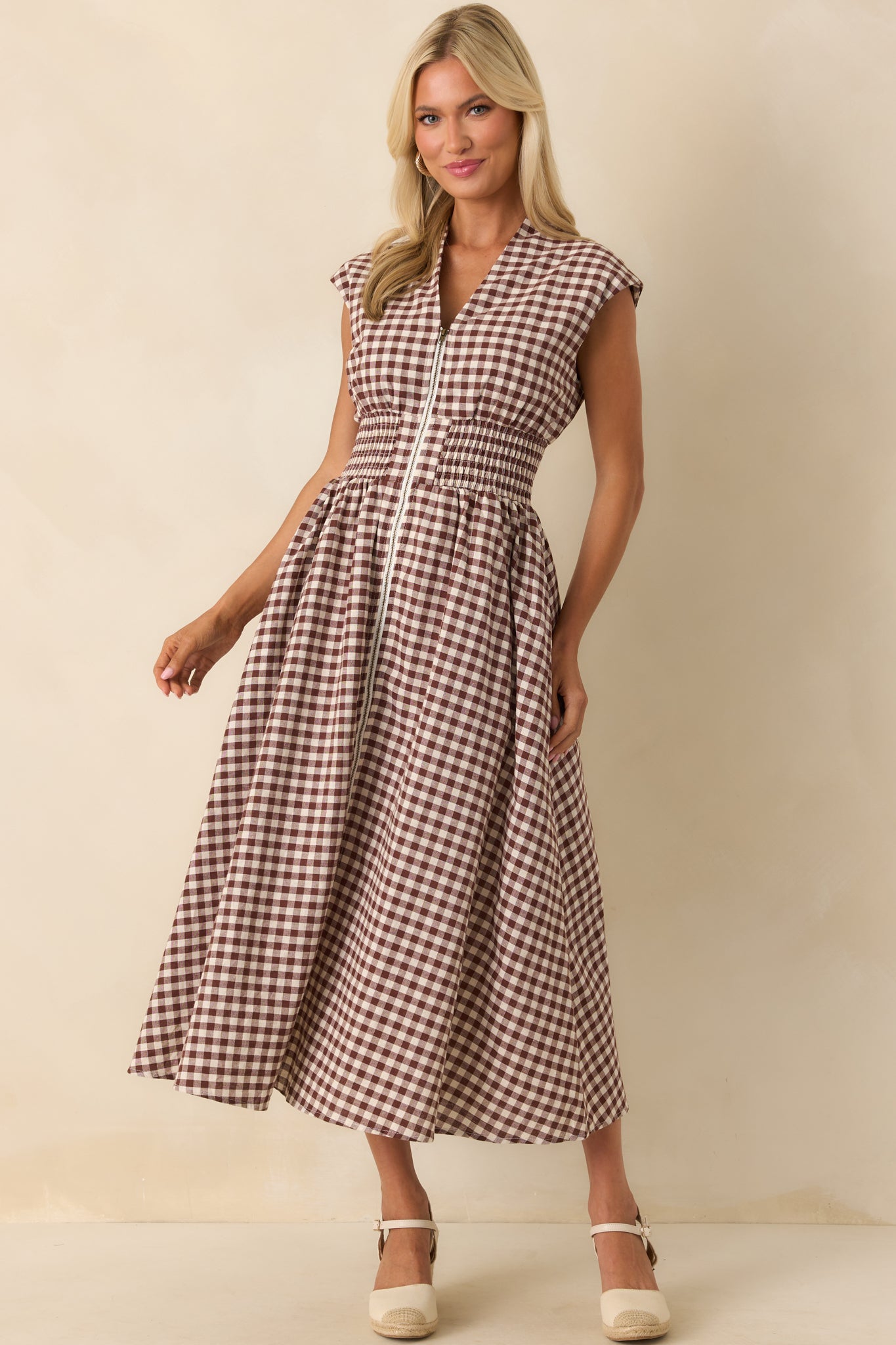Brown gingham midi dress displayed from the front, emphasizing the structured shoulders and fitted waist.