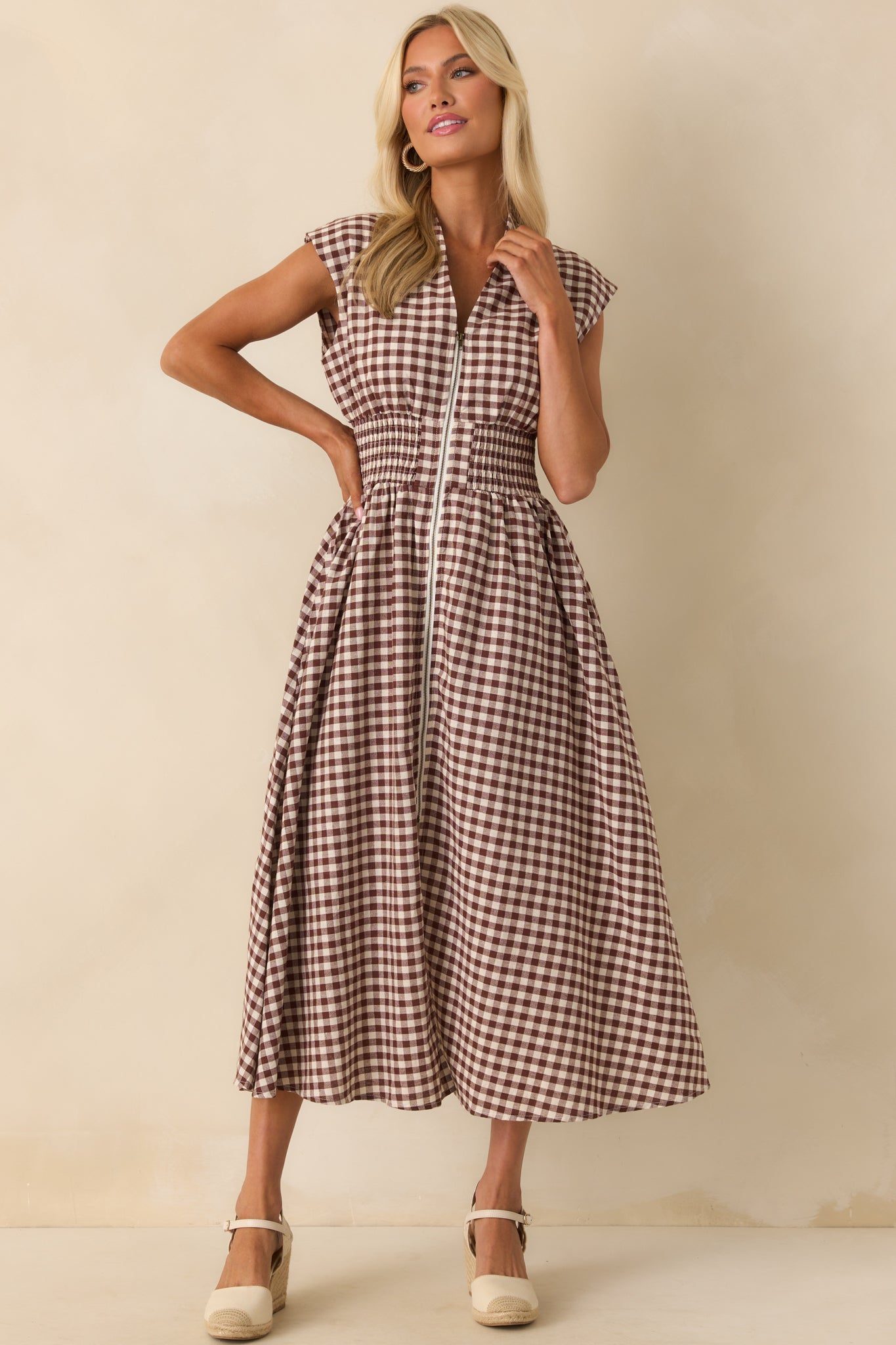 Brown gingham midi dress with a v-neckline, padded shoulders, and capped sleeves shown in a full front view.