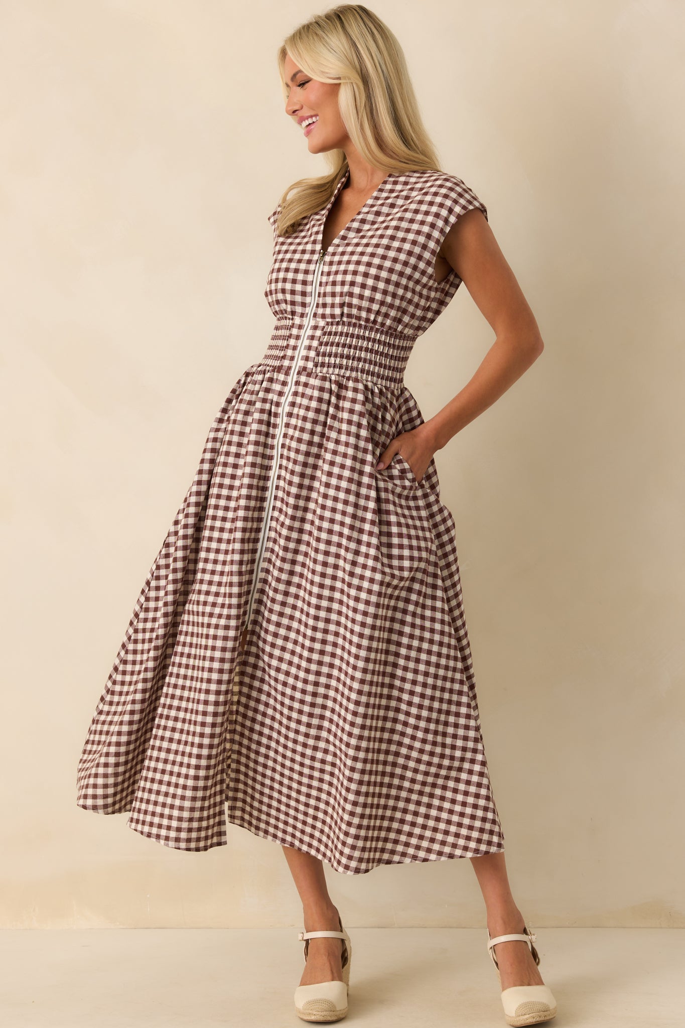 Front-facing angle of the brown gingham dress with capped sleeves, zipper closure, and subtle front slit