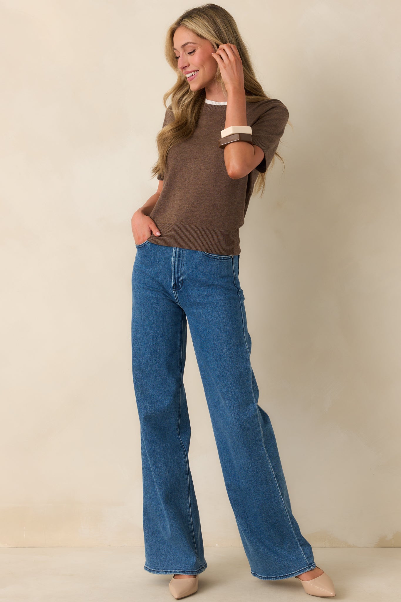 Full body view of the brown top highlighting its soft knit material and overall relaxed fit.