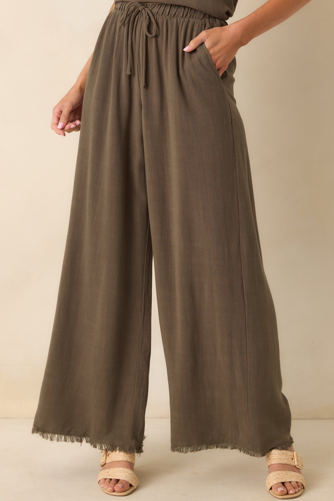 Cropped view of the waistband area, emphasizing the elastic band and tied drawstring detail.