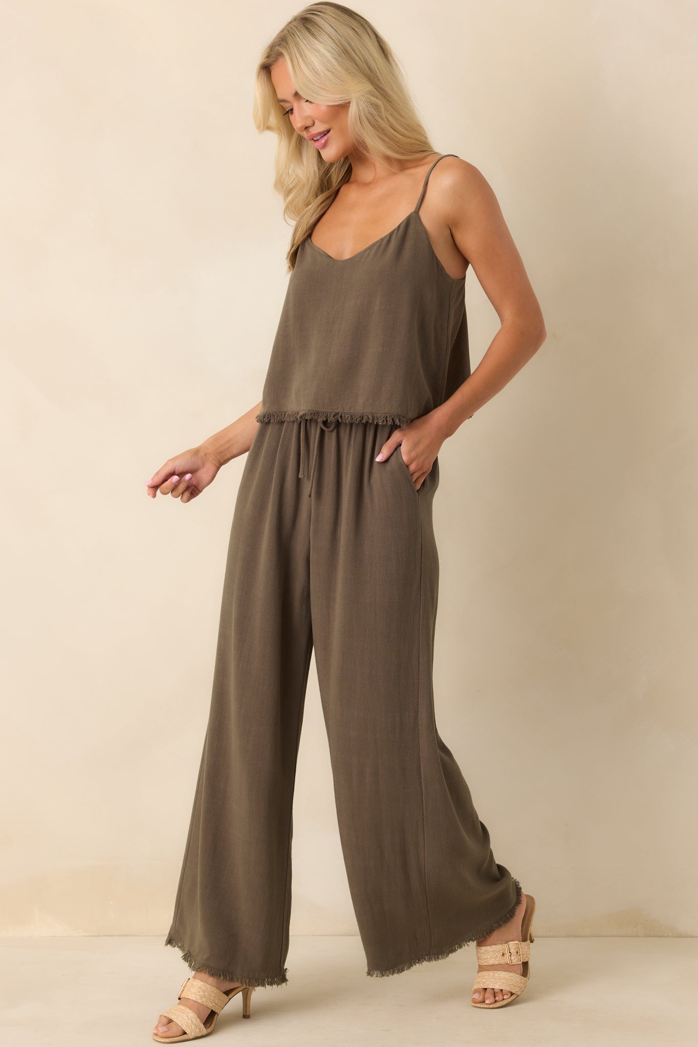 Angled full body photo highlighting the elastic waistband with functional drawstring self-tie and relaxed fit.
