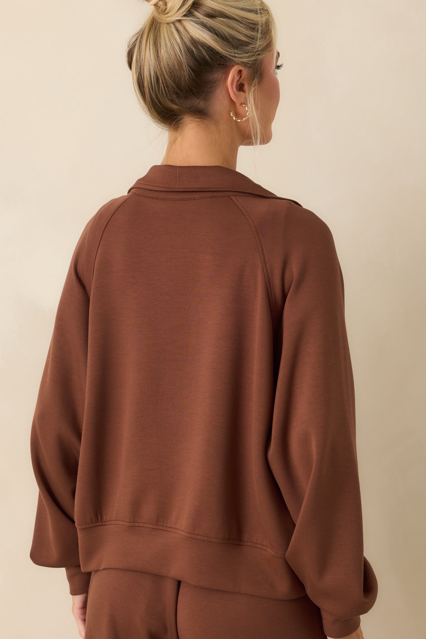 A view from behind of the jacket showing the thick bottom hem and clean back design.