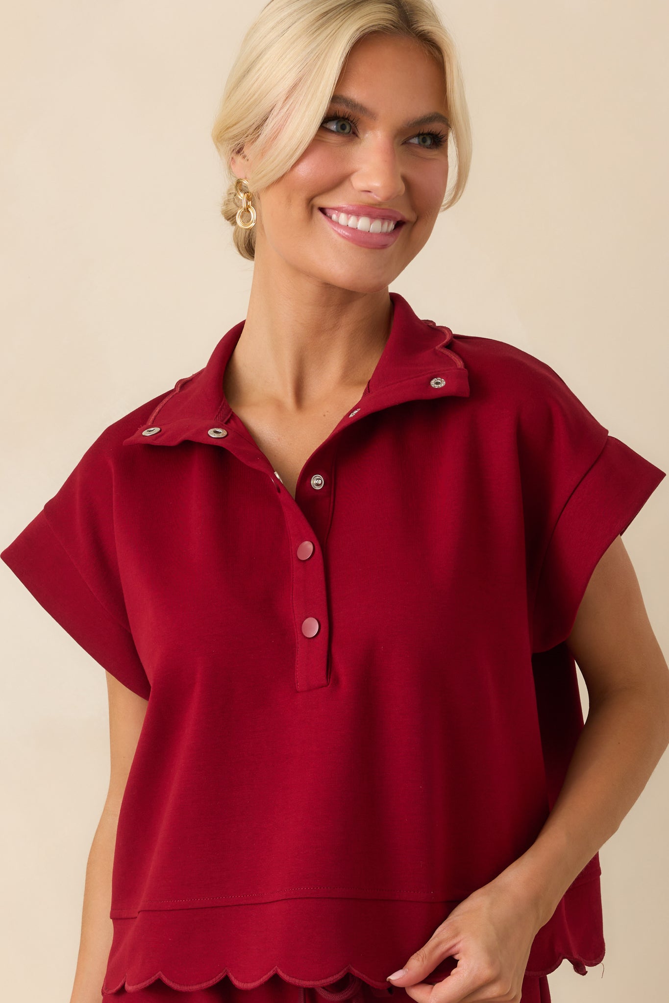 A cropped front view focusing on the collar and snap button placket, showing the functional front opening.