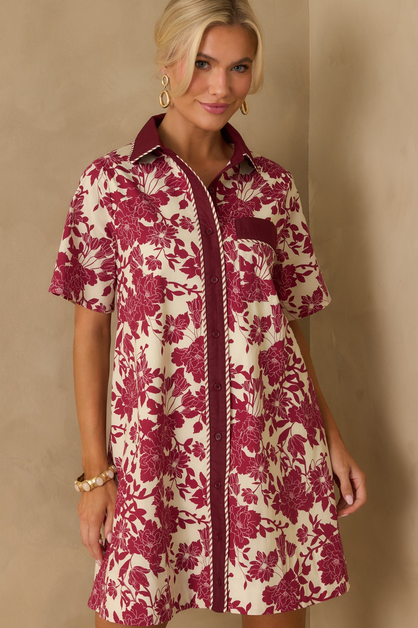 Short sleeve finished with solid burgundy cuff and floral print.