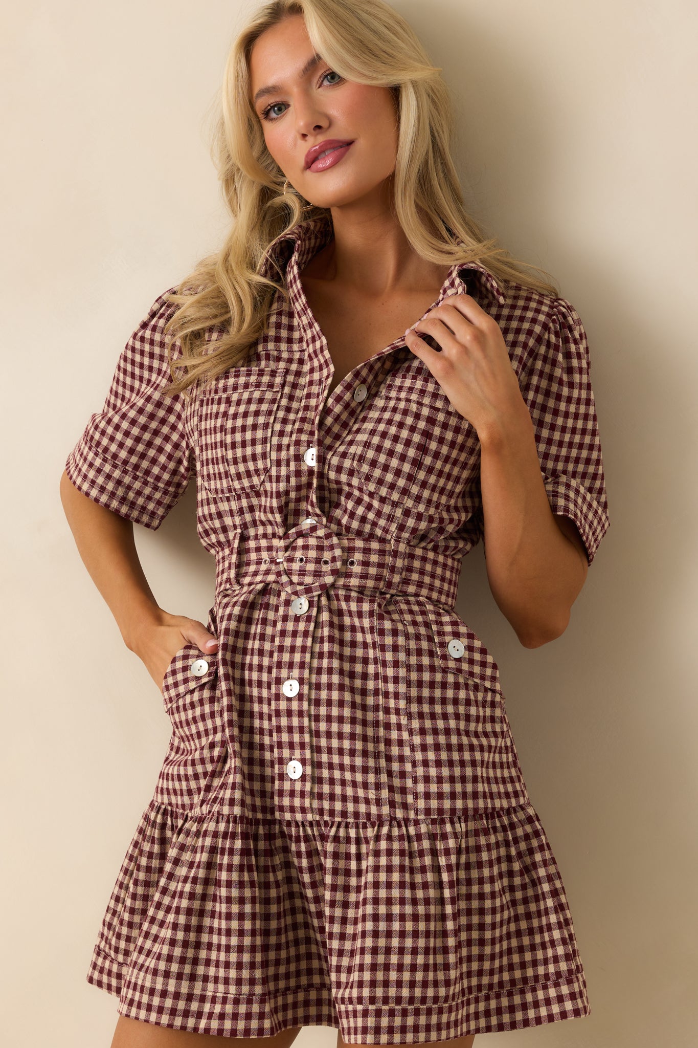 Close view of the cuffed short sleeve and gingham pattern detail.