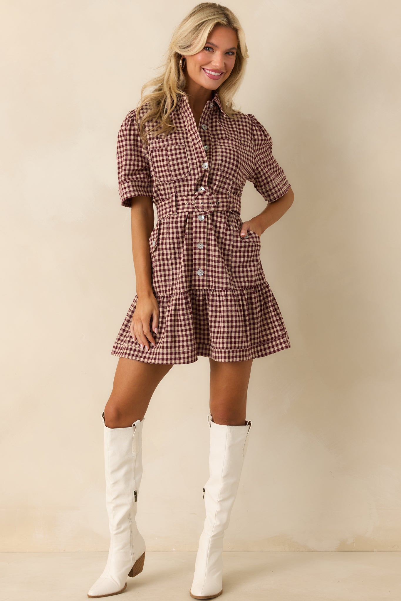 Full view of the burgundy gingham mini dress showing its collared neckline, button front, and tiered skirt.