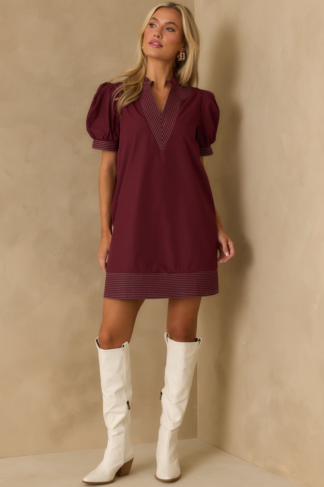 Lined burgundy mini dress with a relaxed fit and notch v-neckline.