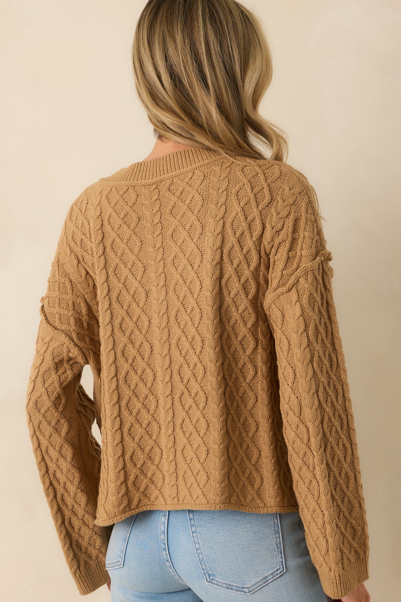 Back view of the camel brown cardigan featuring long sleeves, ribbed hems, and relaxed fit.