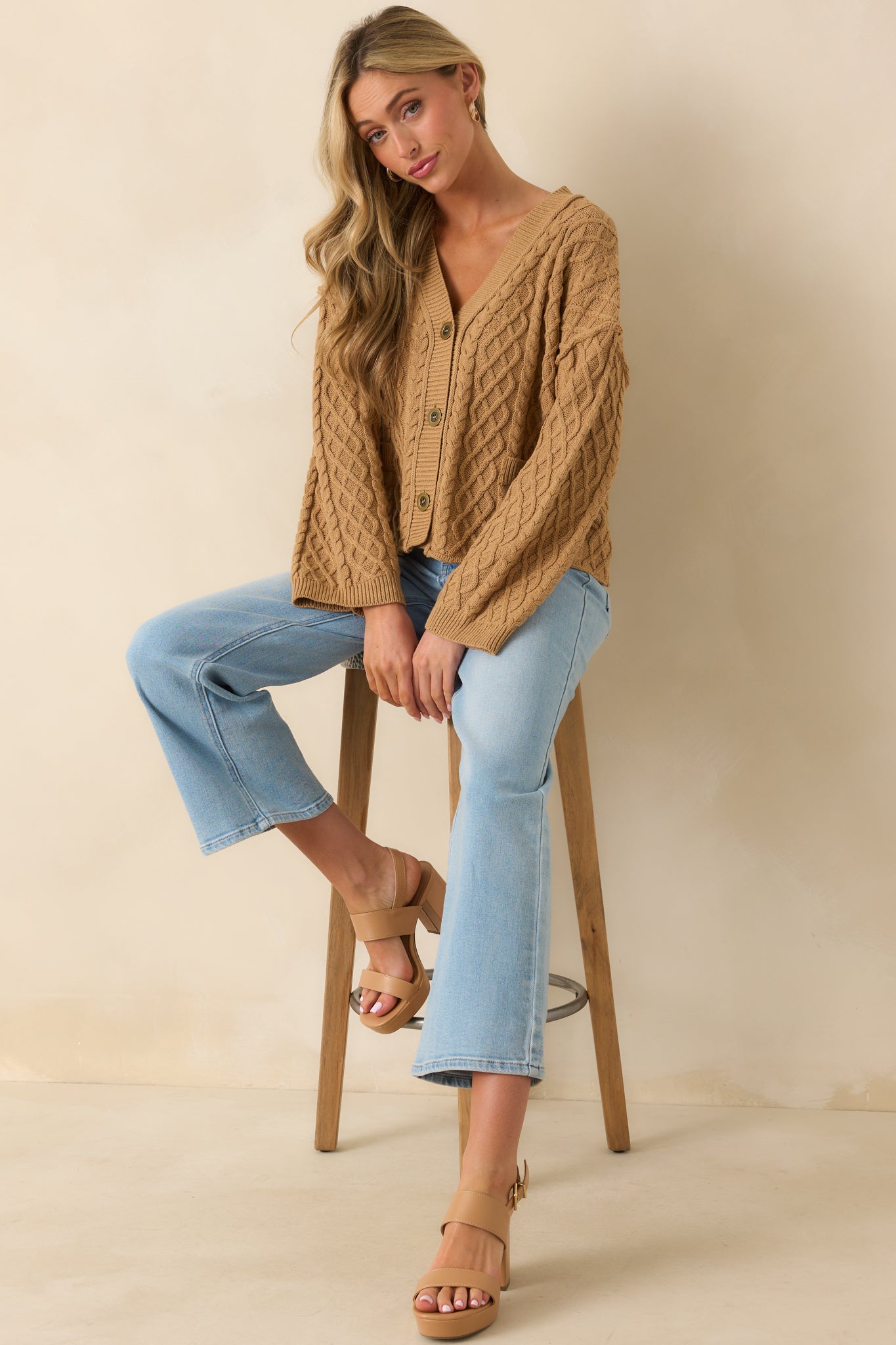Front-facing look at the relaxed fit cardigan featuring faux patch pockets and ribbed hems.