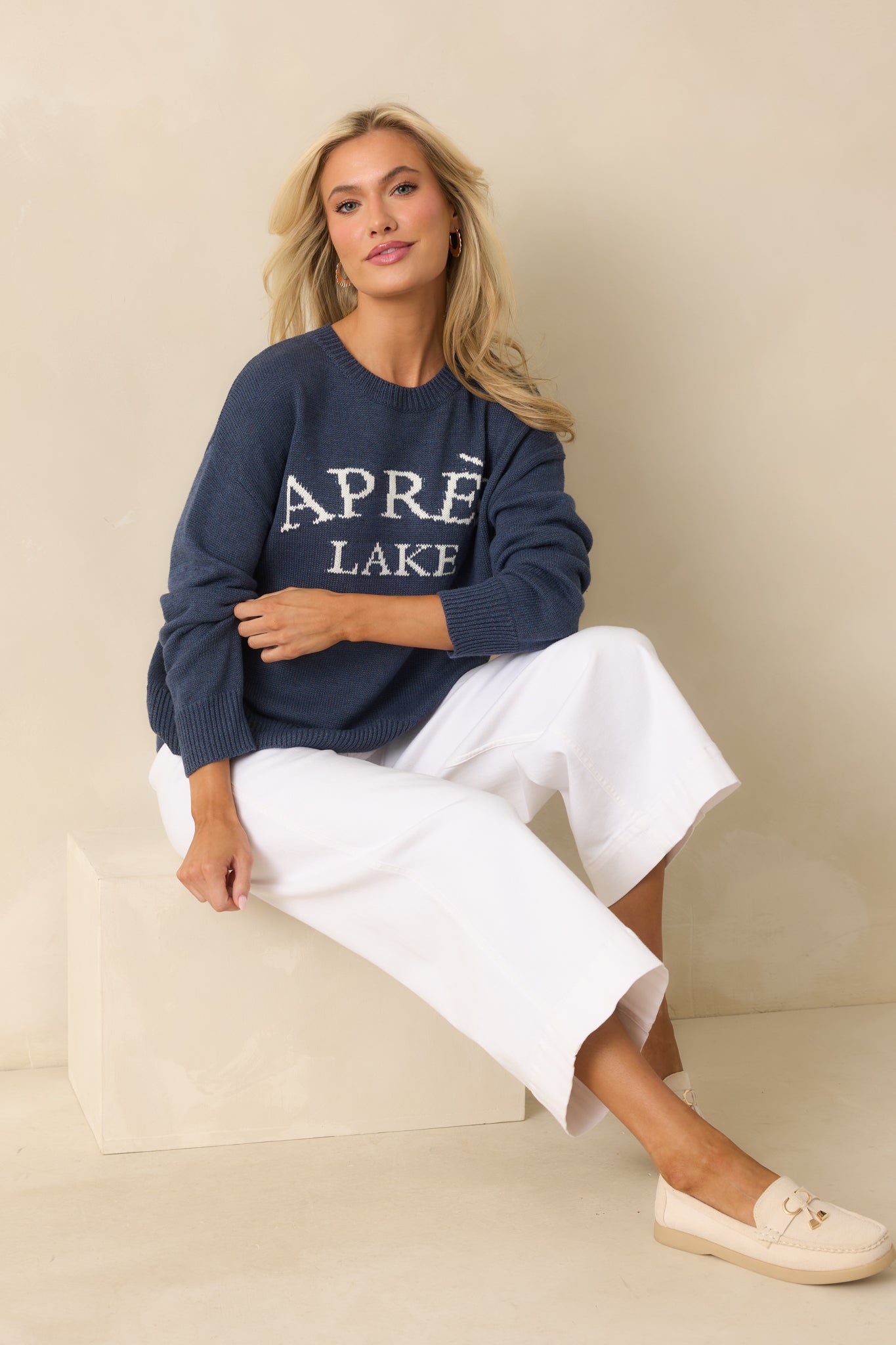 Casual navy sweater with ribbed edges and standout white lettering on the chest.