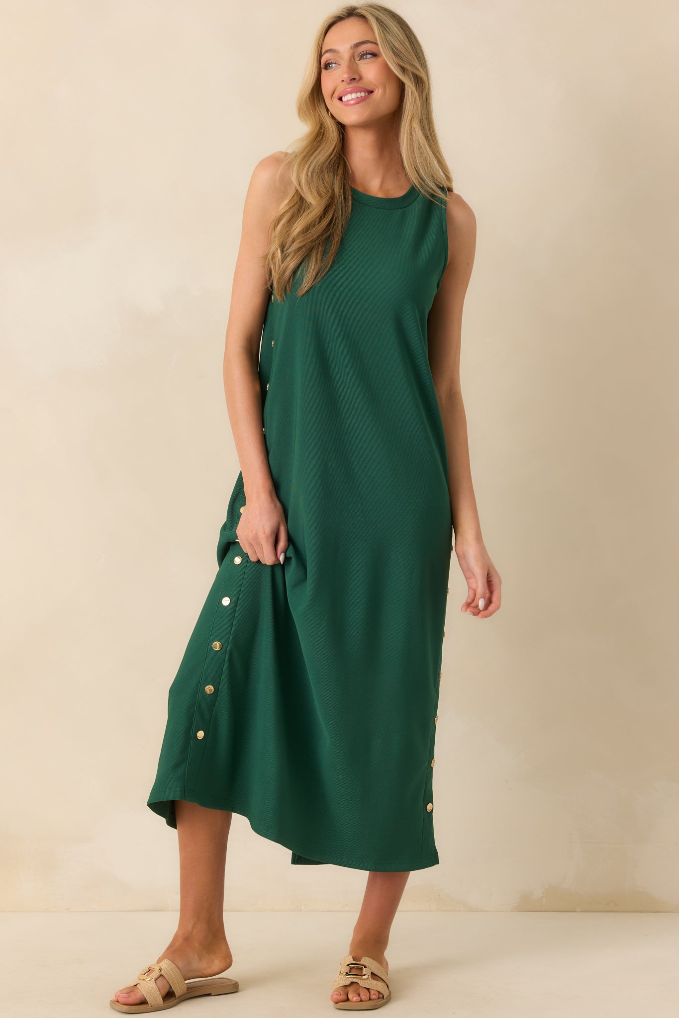 Front-facing full length image highlighting the relaxed fit and decorative gold buttons along the sides.