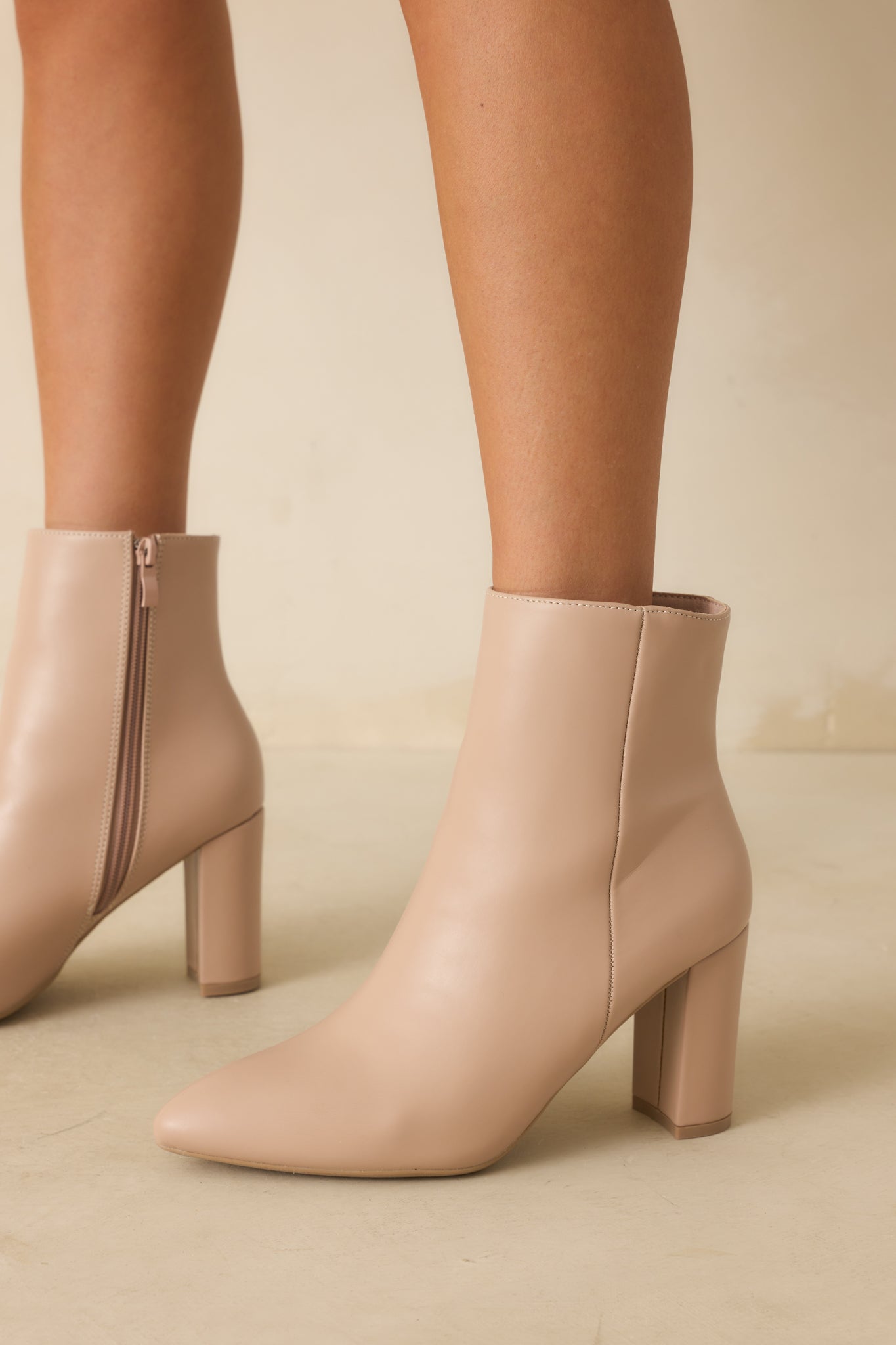 A close-up shot of the boots featuring a block heel and outer seam detailing.