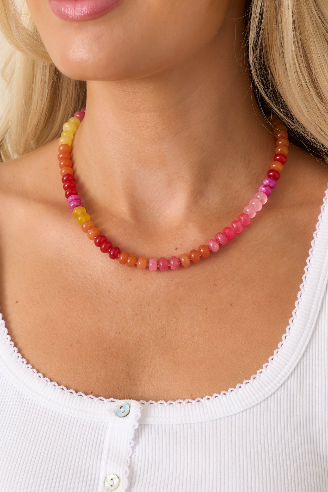 Bright glass bead necklace showcasing a playful blend of warm-toned beads and a delicate gold-tone clasp detail.