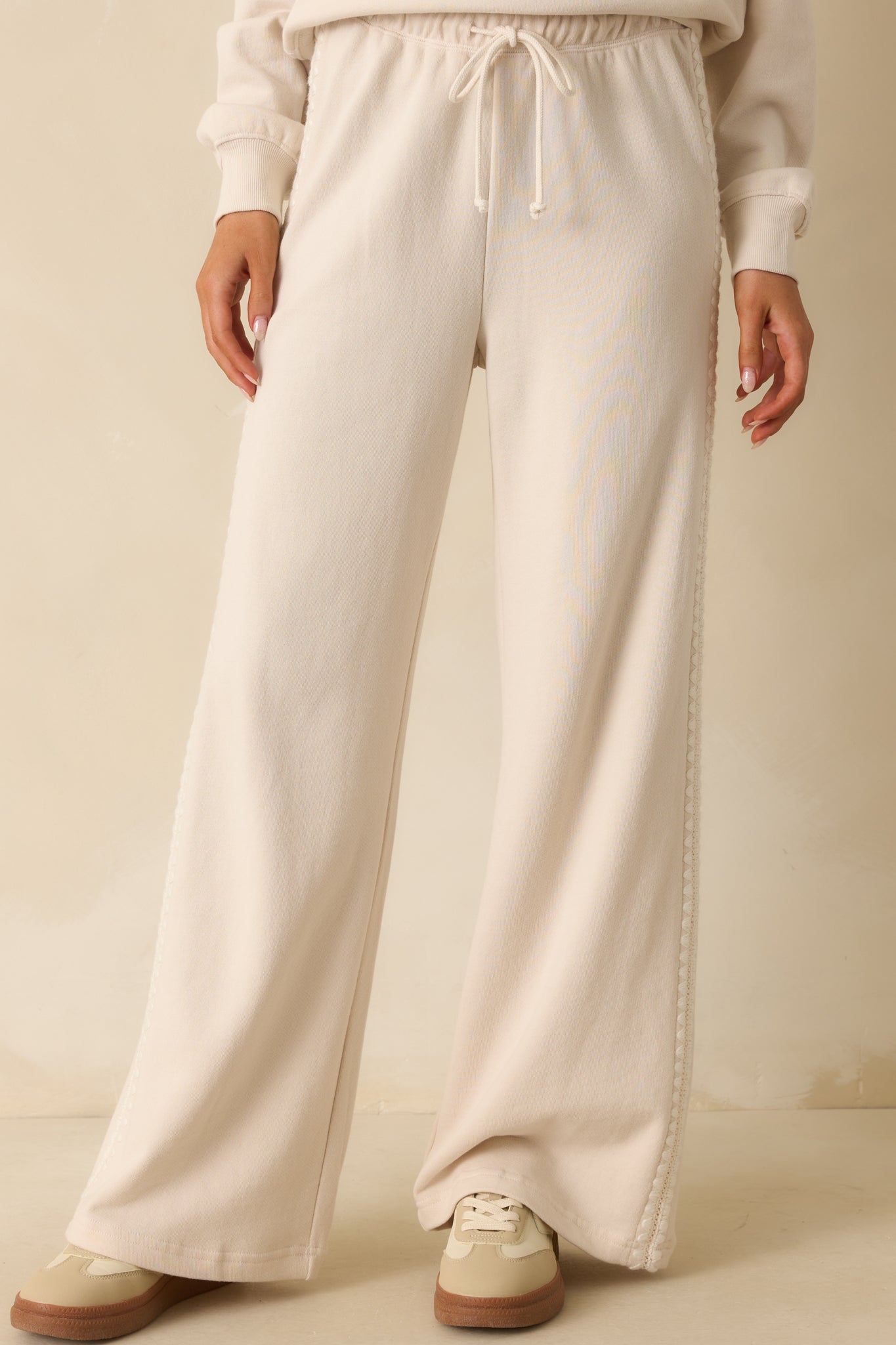Close view of the high-rise waistband with elastic stretch and drawstring tie.