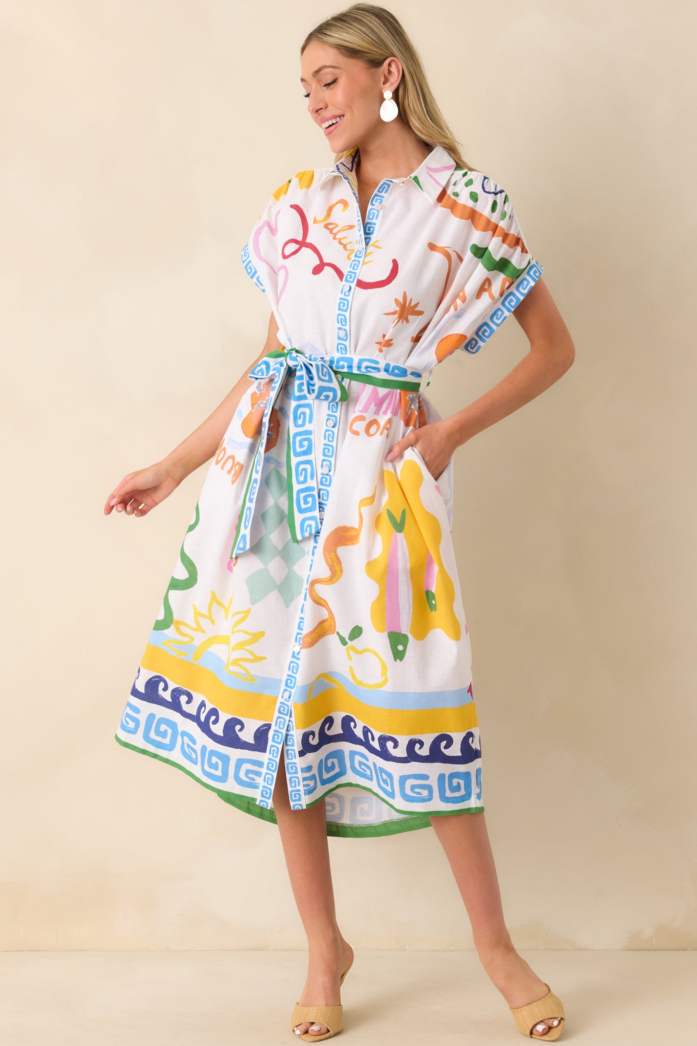 Full length view of the dress with a clear look at the belt loops, short sleeves, and straight-cut midi hem.