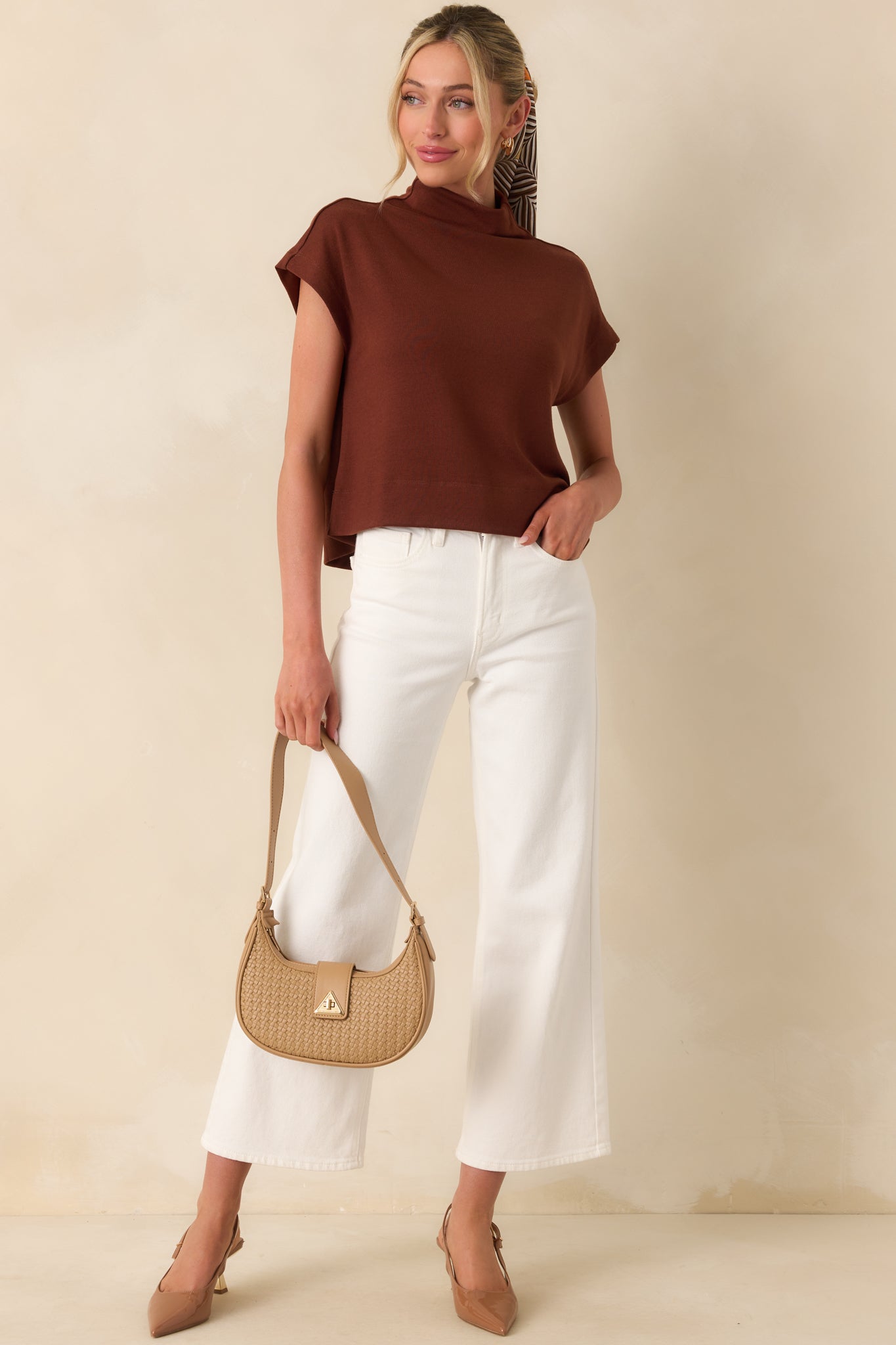 Full body front view of the rust top showing the relaxed roll mock neckline and cap sleeves.