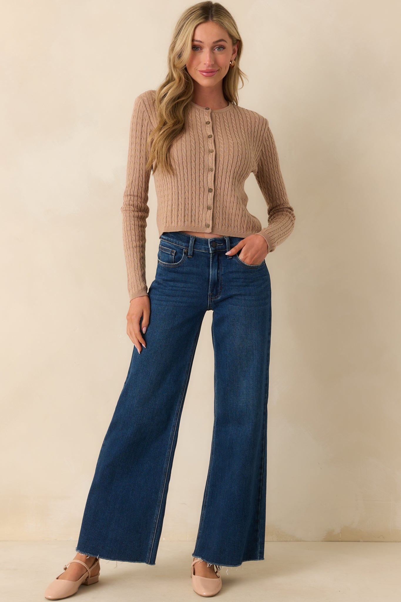 Full body view of the dark taupe cardigan worn over an outfit, showing its full length and slightly fitted silhouette.