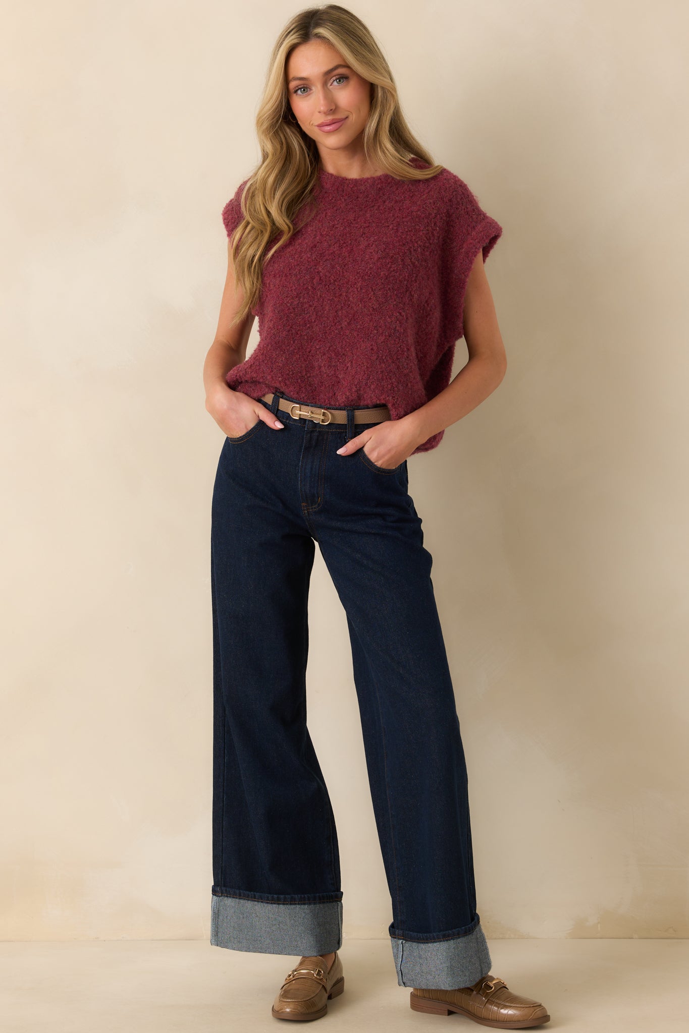 Full front shot highlighting the fitted shape, dark denim color, and button zipper closure.