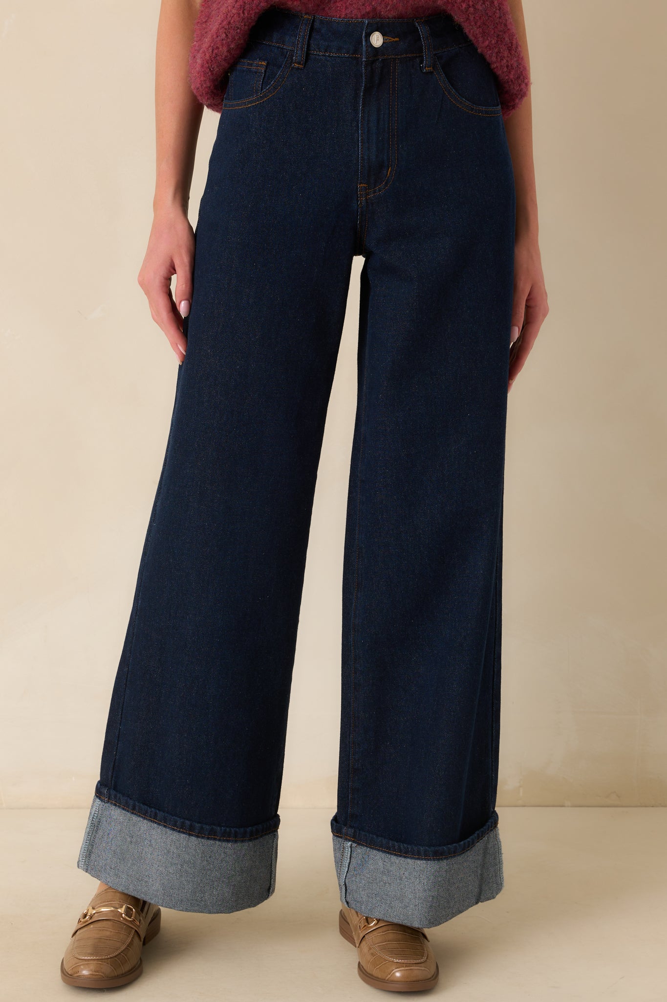 Mid-leg cropped image highlighting the sewn hem cuffs and dark denim texture.
