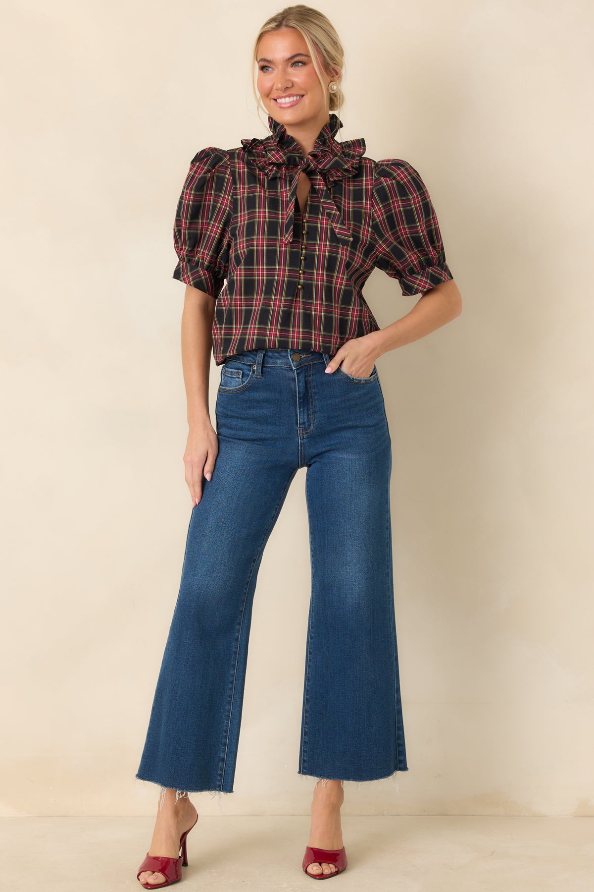 Medium-wash high-waisted jeans with wide cropped legs, front pockets, and raw hems.