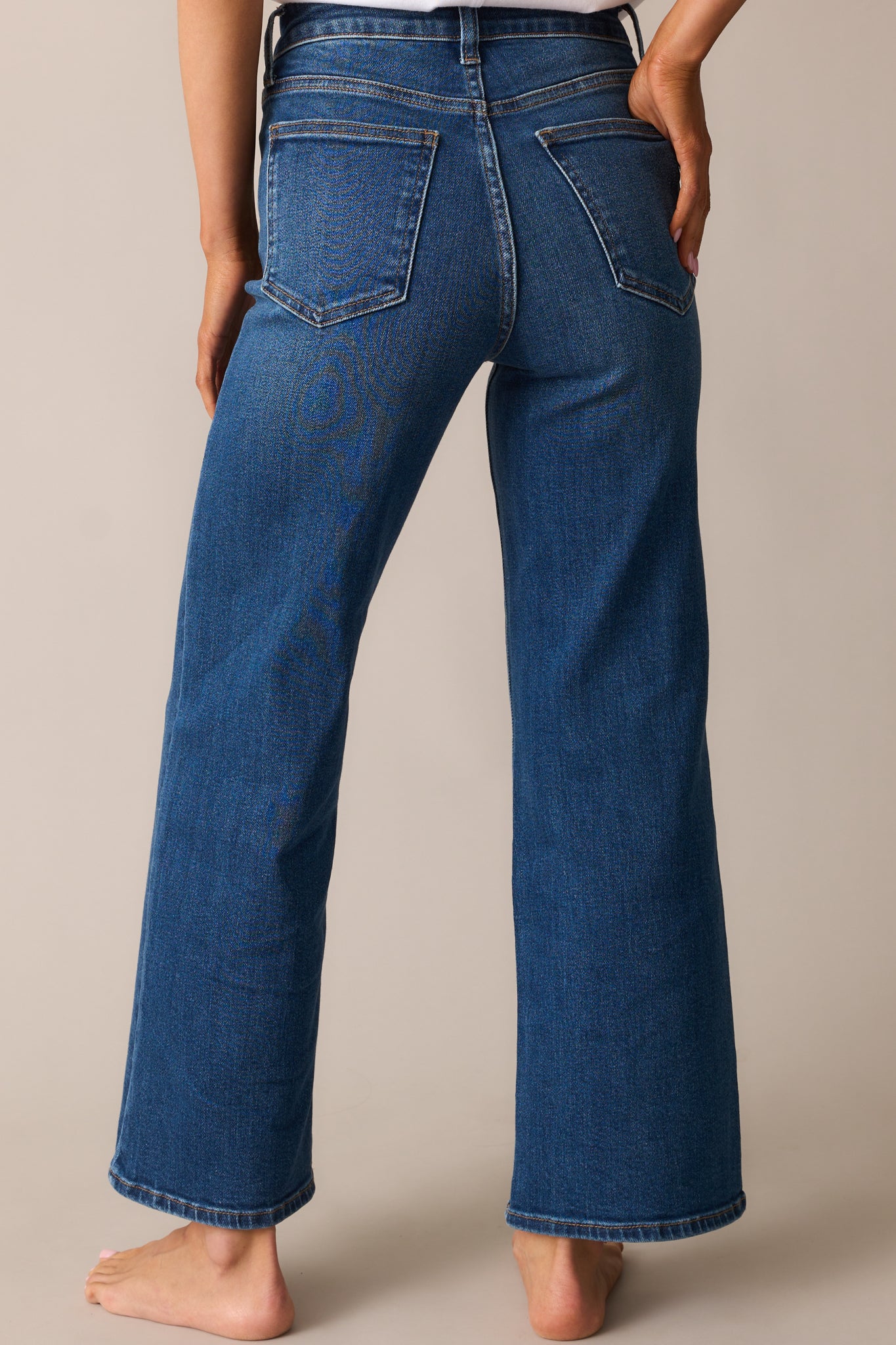 The wide-leg jeans viewed from behind, displaying the high-waisted fit, back pockets, and slightly cropped hem.