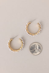 Size comparison of these Elegant earrings adorned with gold hardware, faux pearls, and shimmering rhinestones, complete with secure post backings for effortless wear.