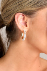 These earrings feature gold hardware, faux pearls, rhinestones, and secure post backings. 