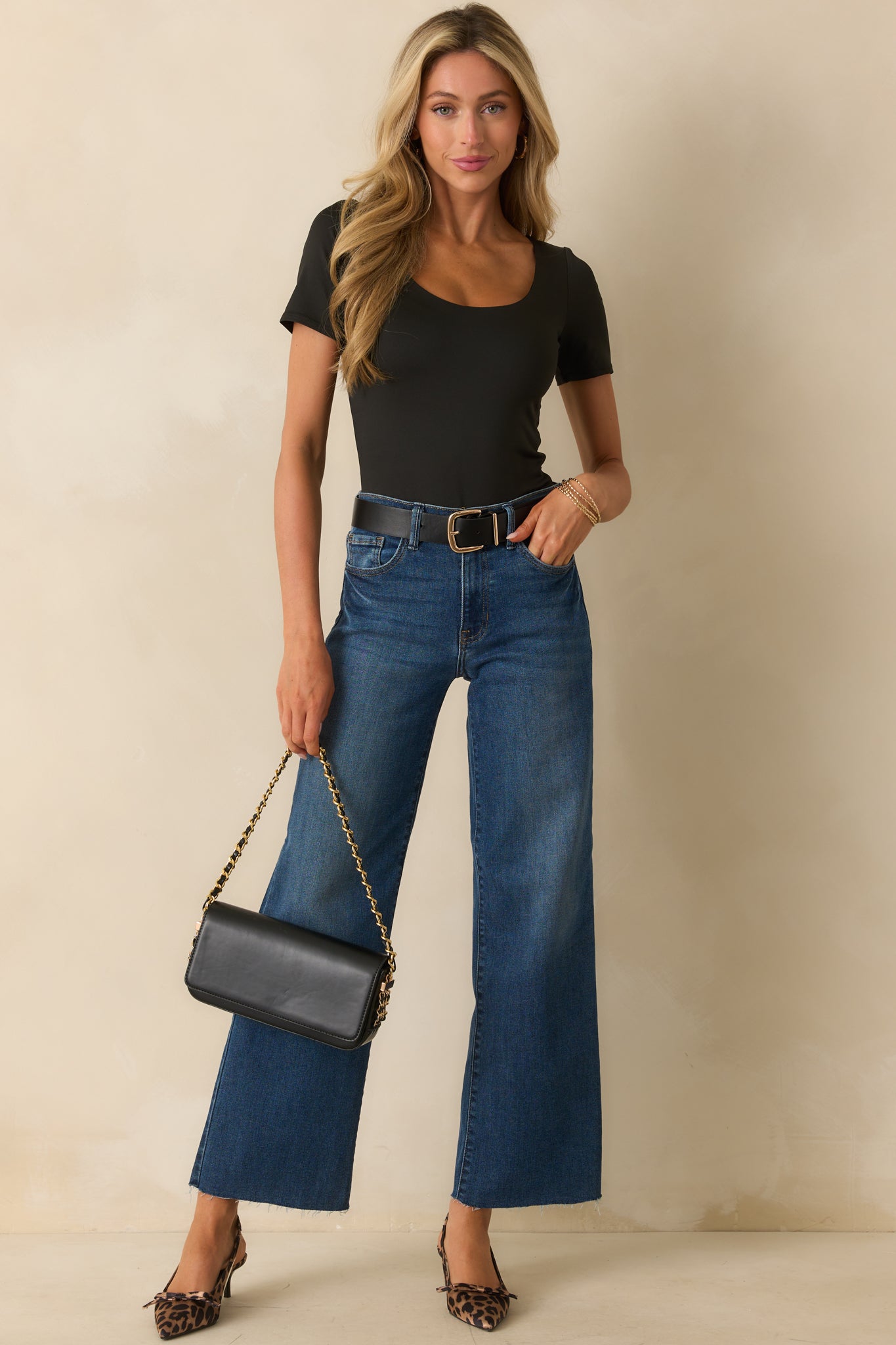 Fitted black bodysuit with a smooth, streamlined look.