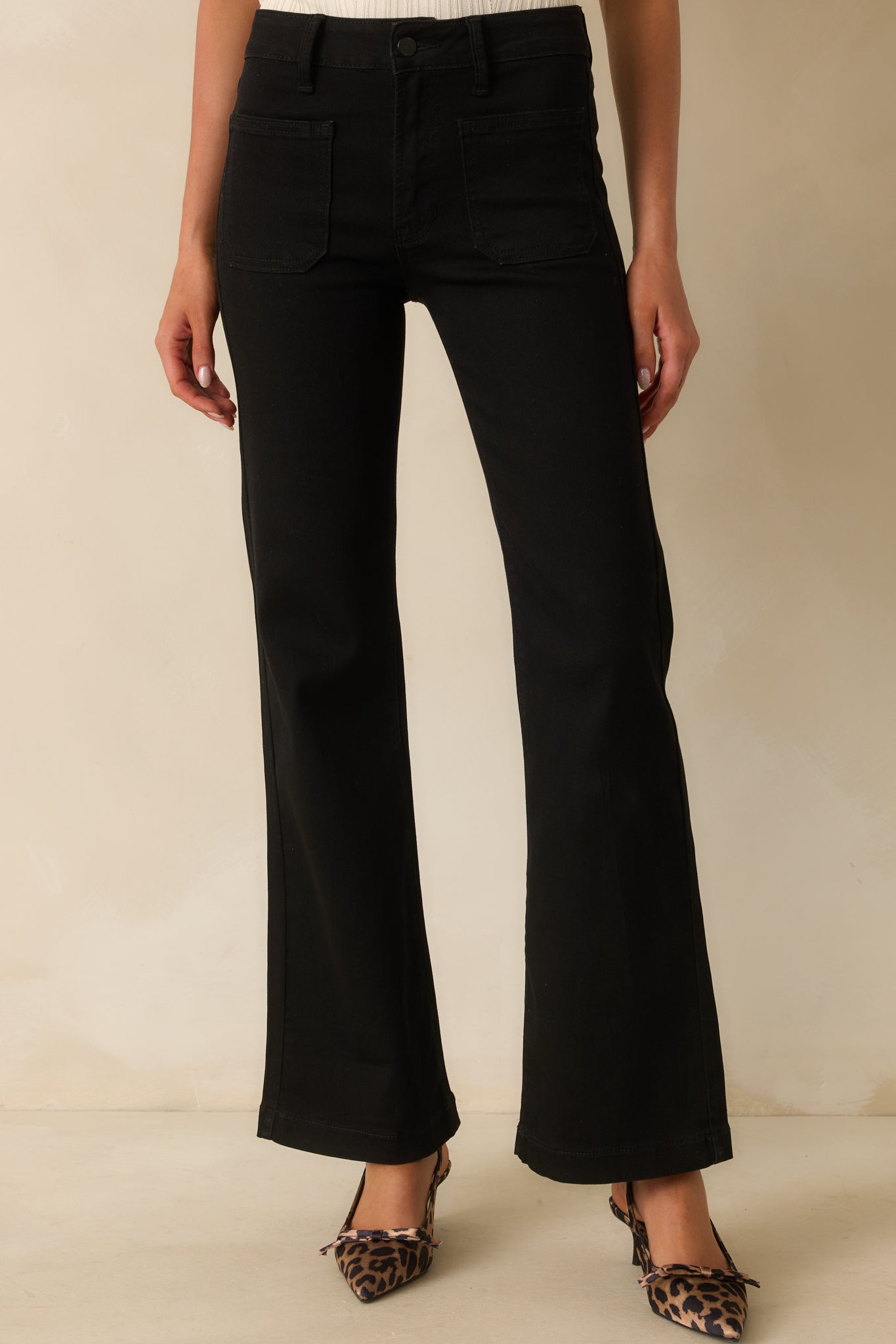 A cropped front view showing the zipper button closure and functional patch pockets.