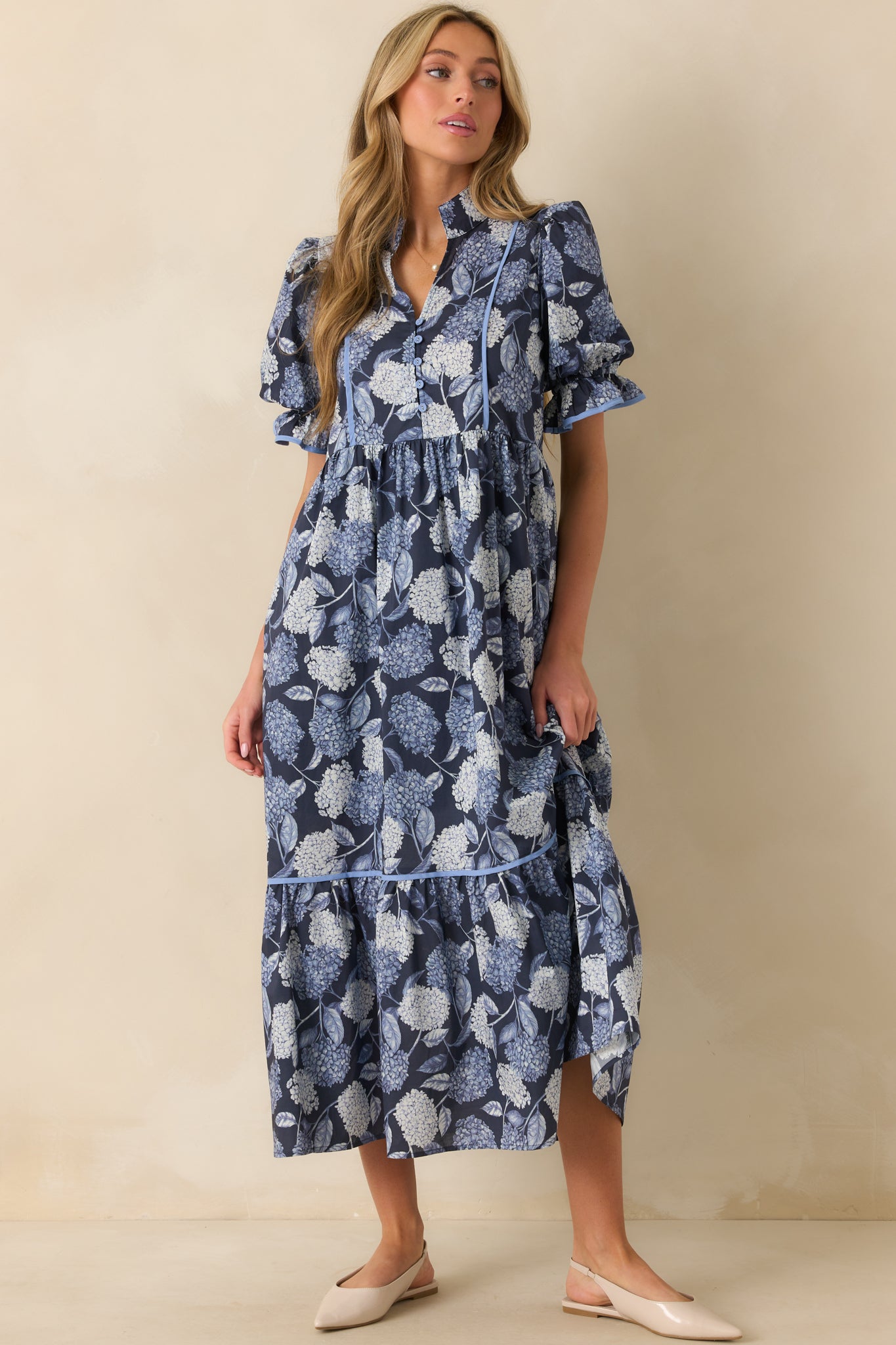 A full-body view of the floral maxi dress showing the fitted bust and relaxed drape through the skirt.